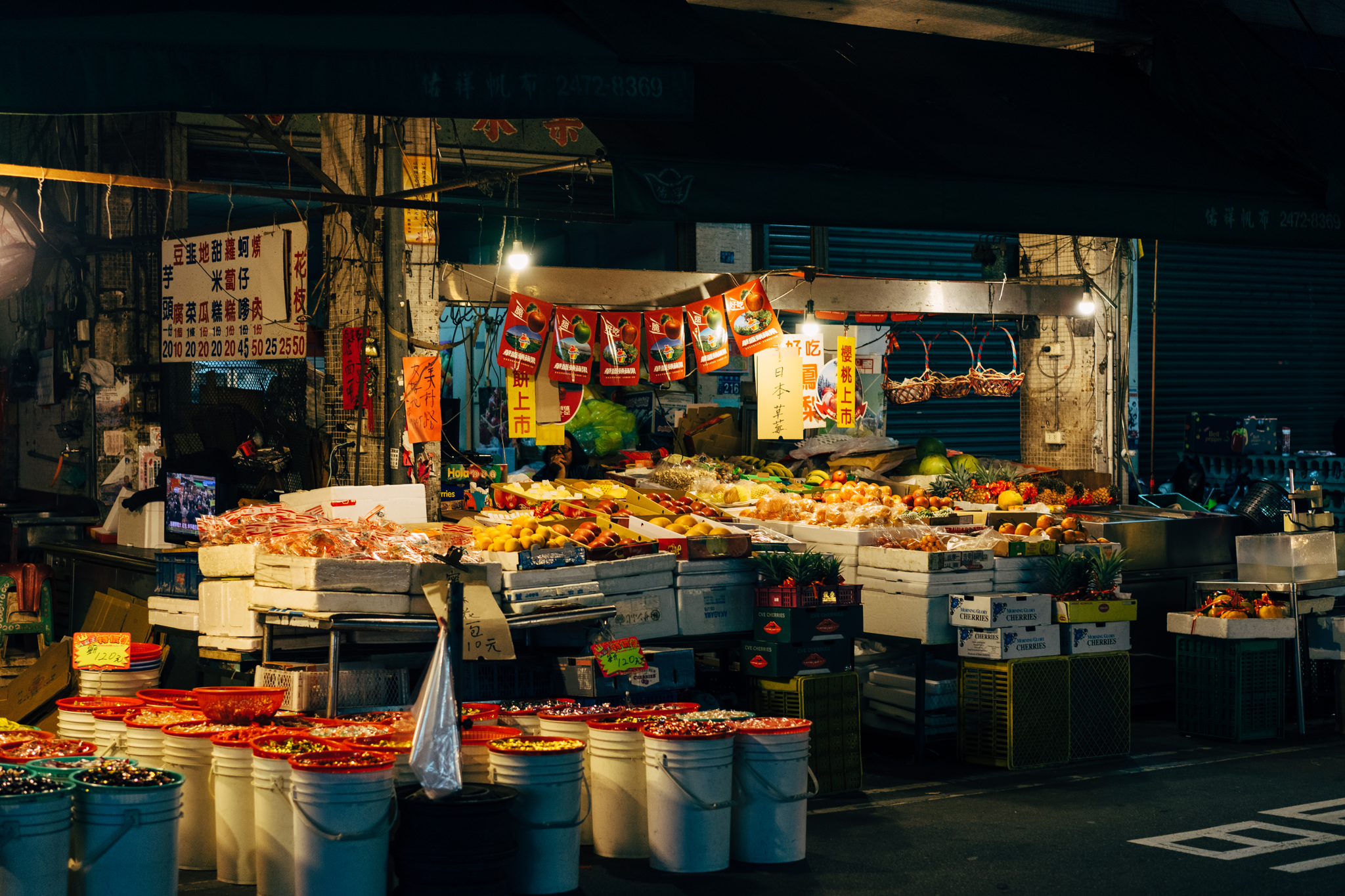 Nighttime view of a fruit and candy stand in Taichung City, Taiwan.