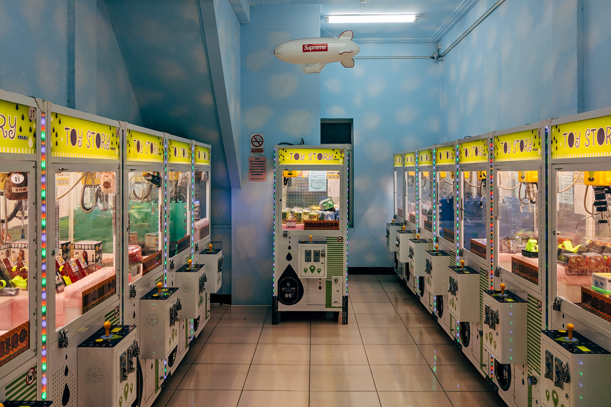 Row of Toy Story claw machines in an arcade.