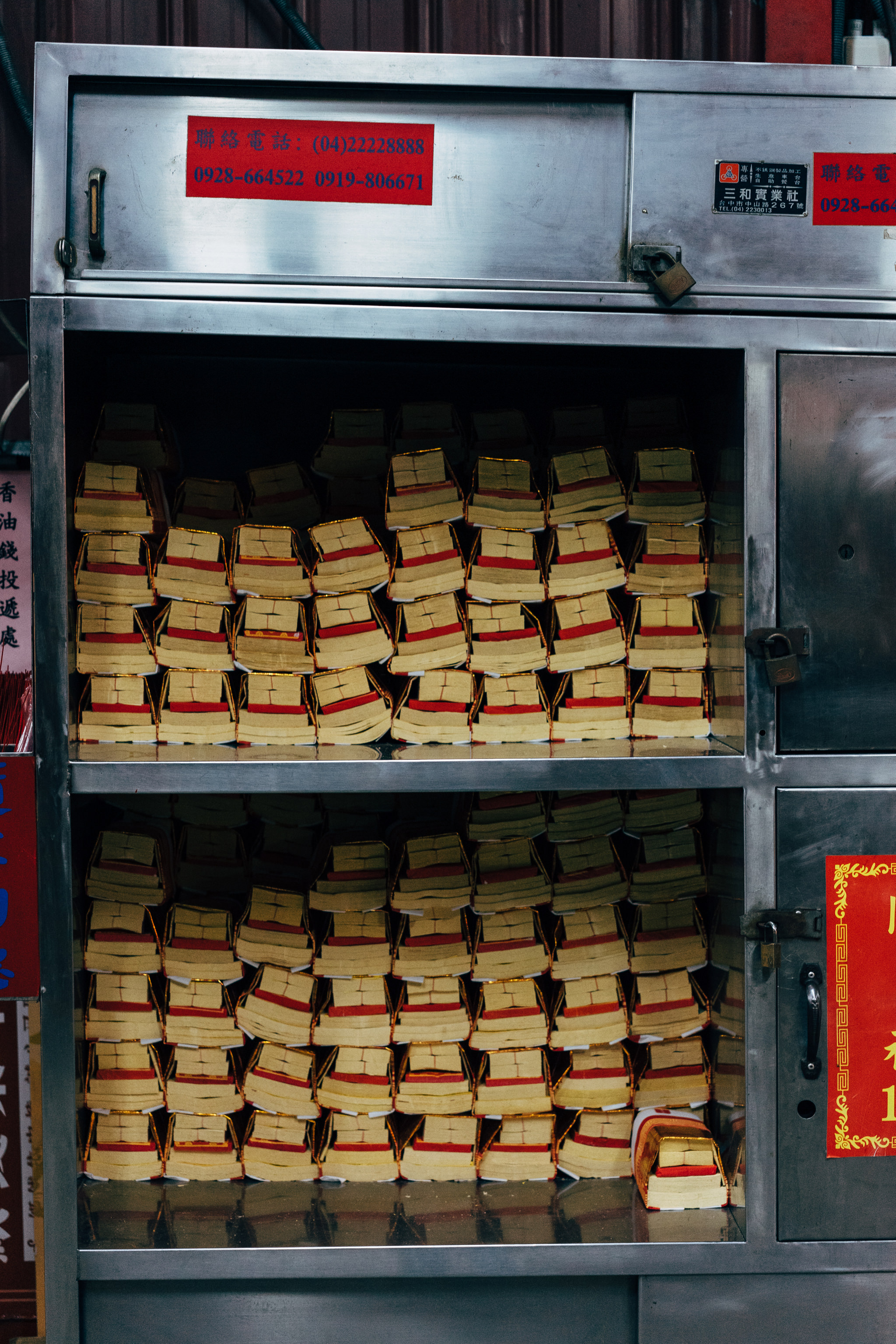 Metal cabinet with stacks of joss paper.