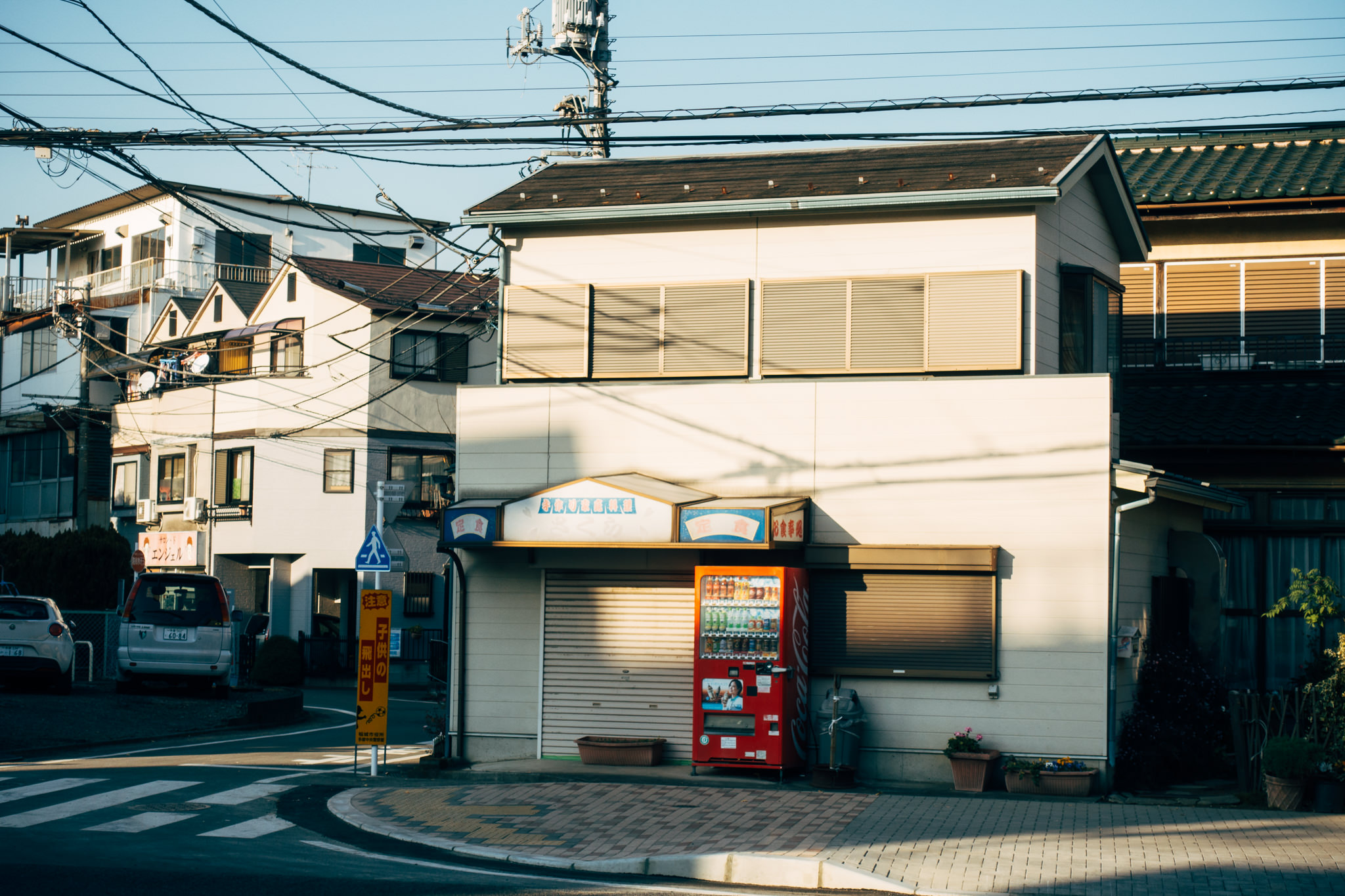A vending machine sits outside a small building in Tokyo, Japan.