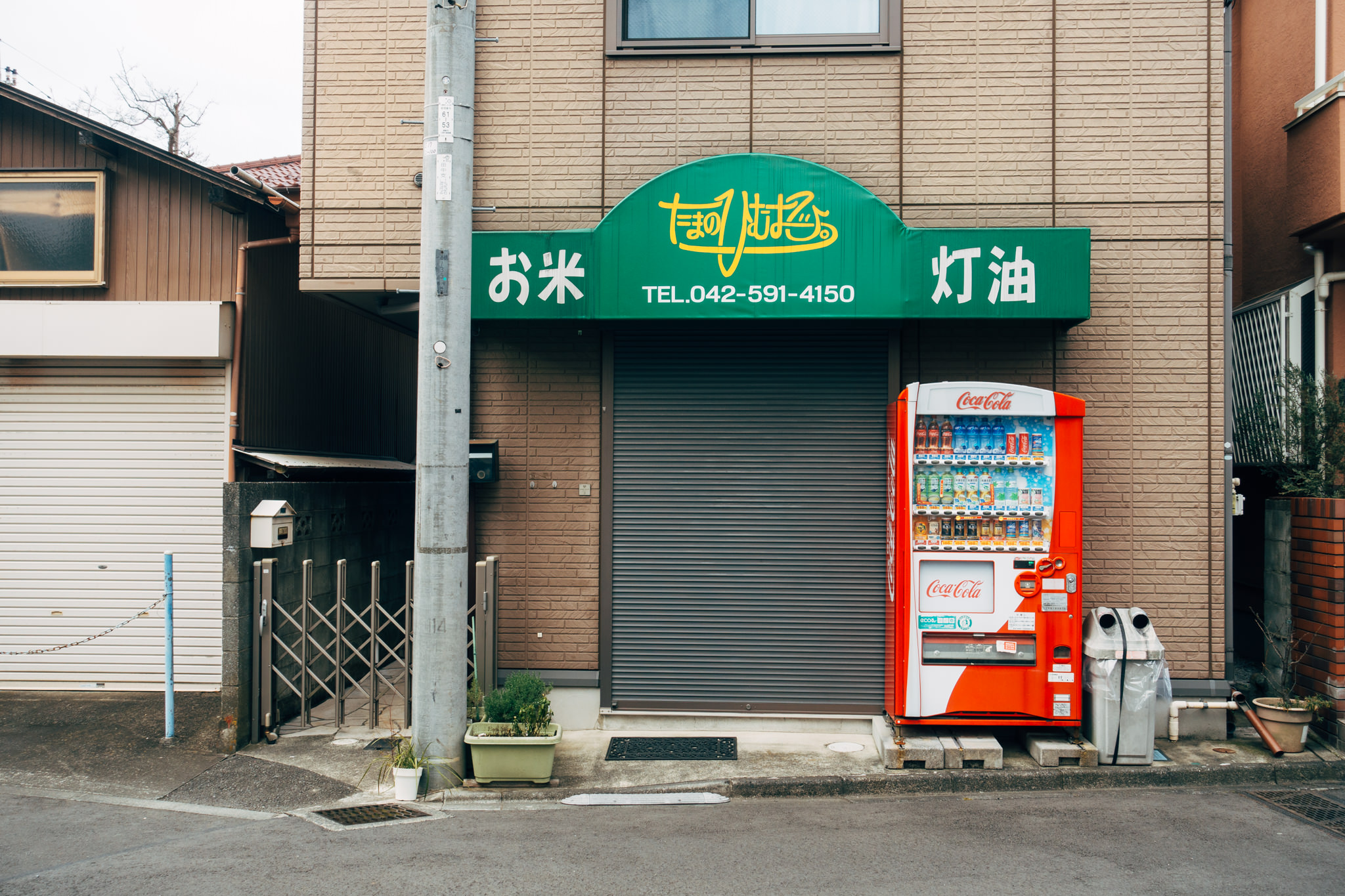 Japanese storefront with a Coca-Cola vending machine.