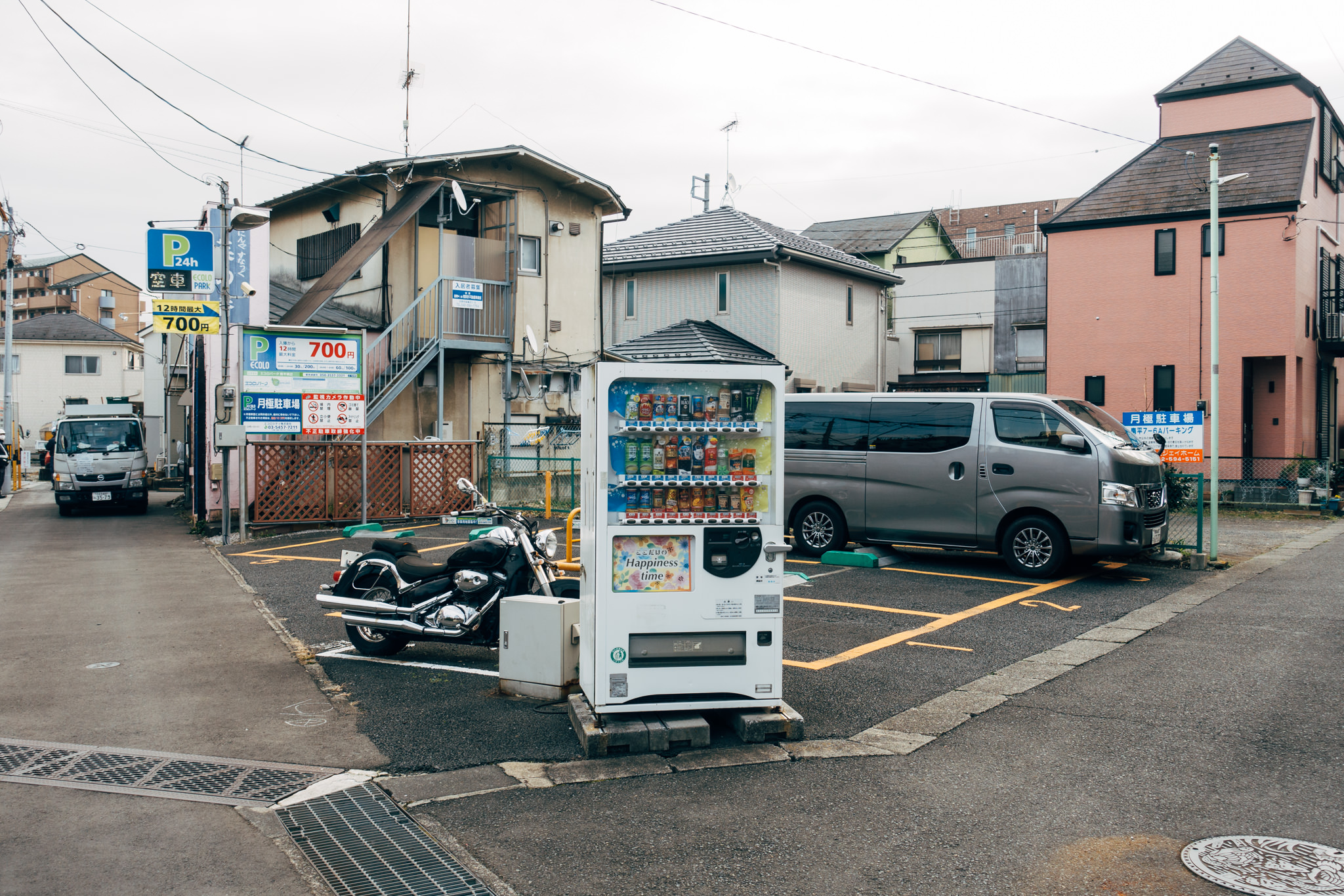 Japanese vending machine in a parking lot.