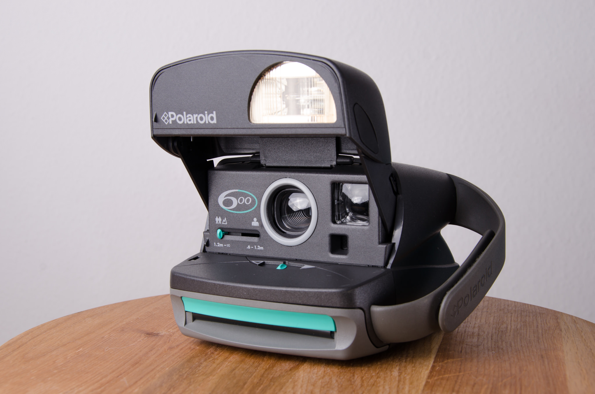 Polaroid 600 instant camera with flash open.