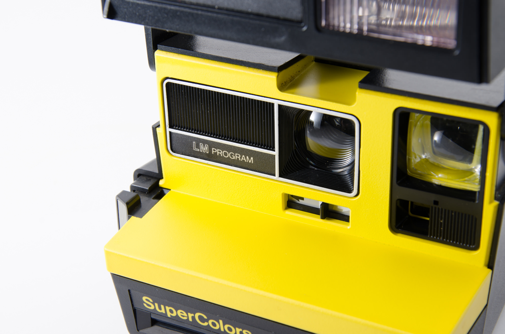 Close-up of a yellow Polaroid SuperColor LM Program instant camera.