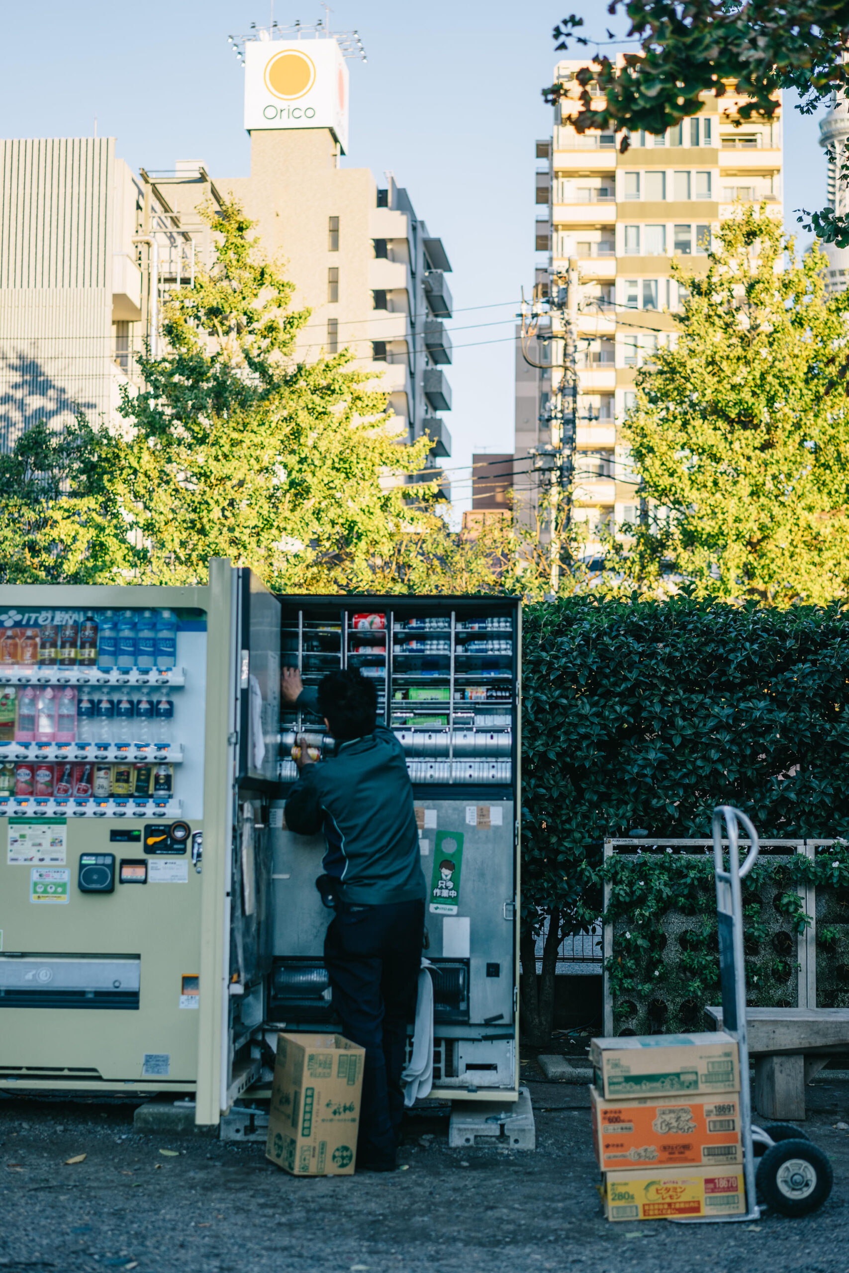 A worker restocking a vending machine.