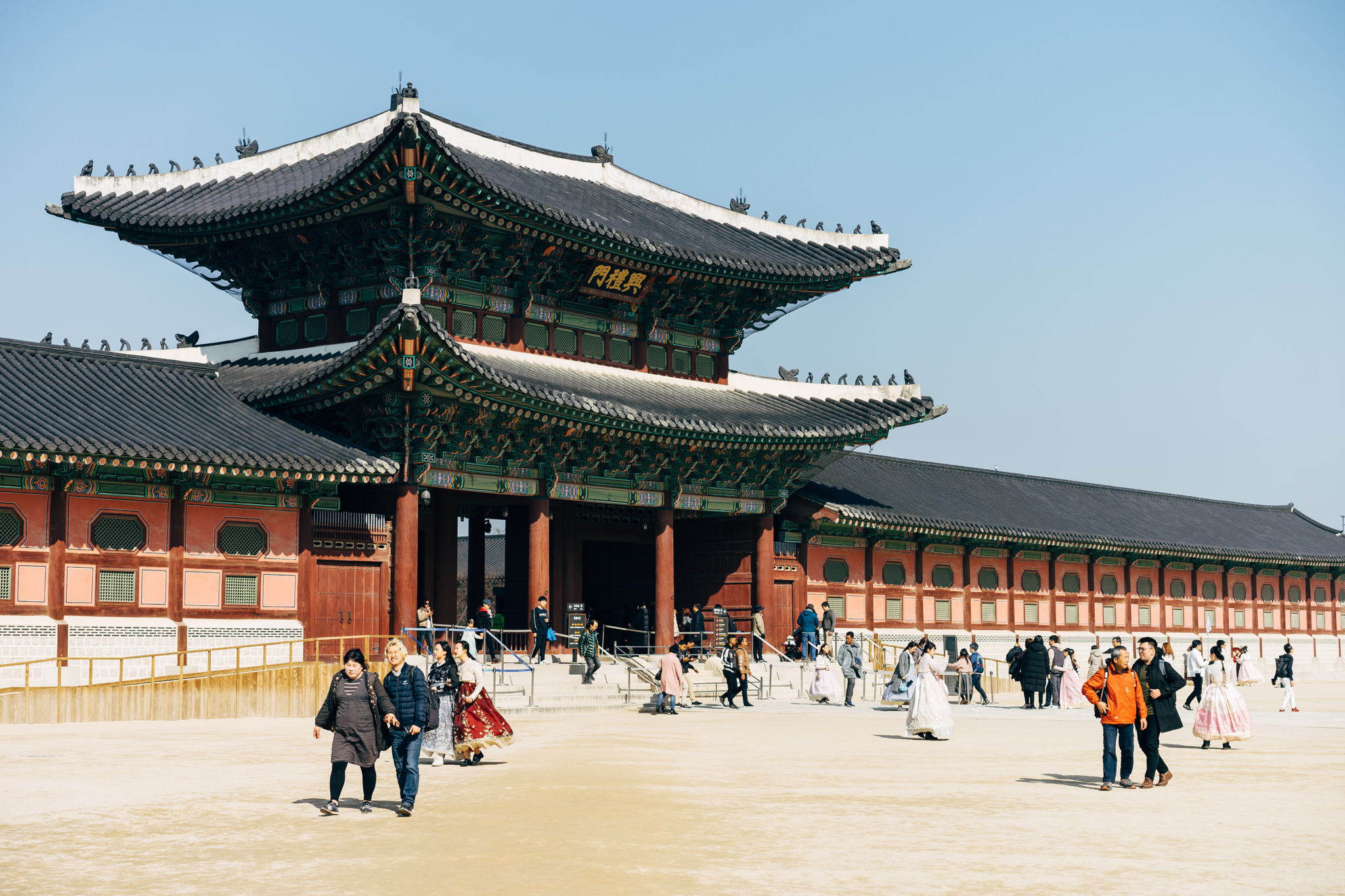 Gyeongbokgung Palace gate and courtyard with visitors.