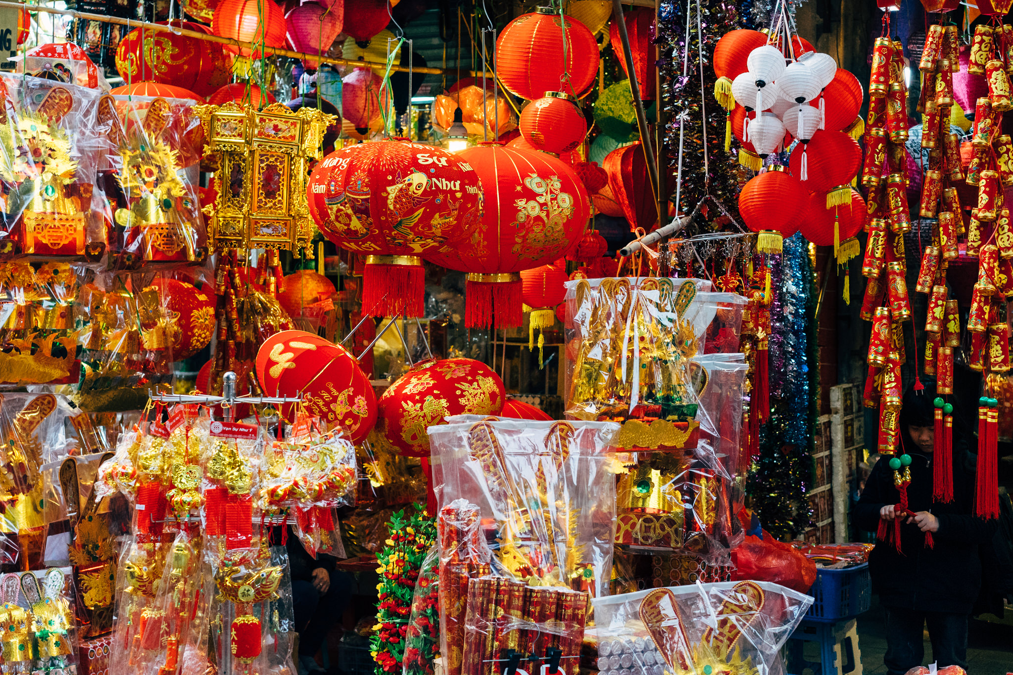 Vietnamese New Year decorations and lanterns at a market stall.