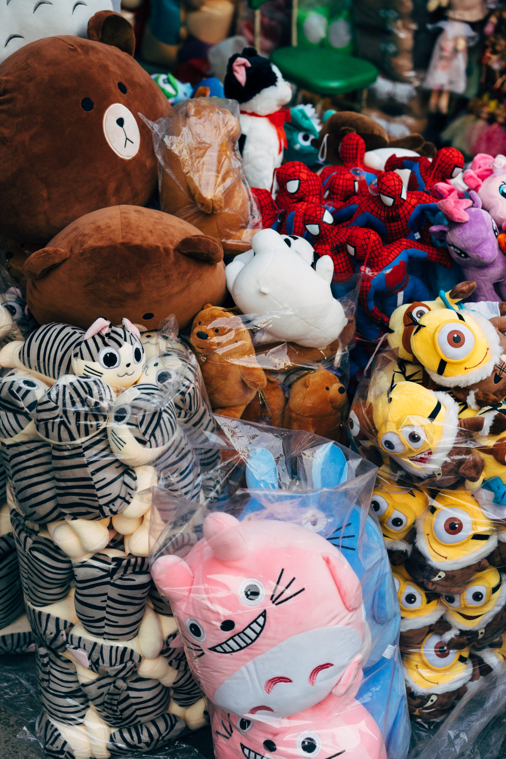 Pile of stuffed animals in plastic bags.
