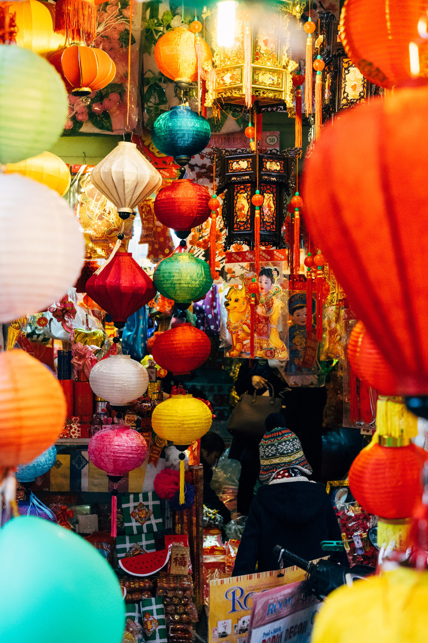 Colorful lanterns and holiday decorations at a market.