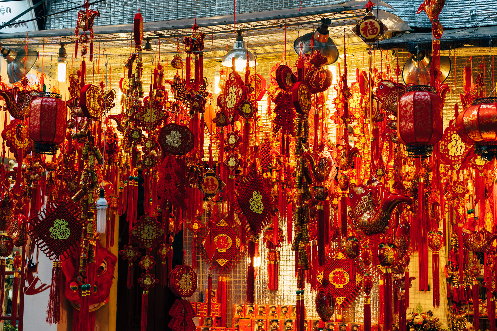 Many red Chinese New Year decorations hanging in a shop.
