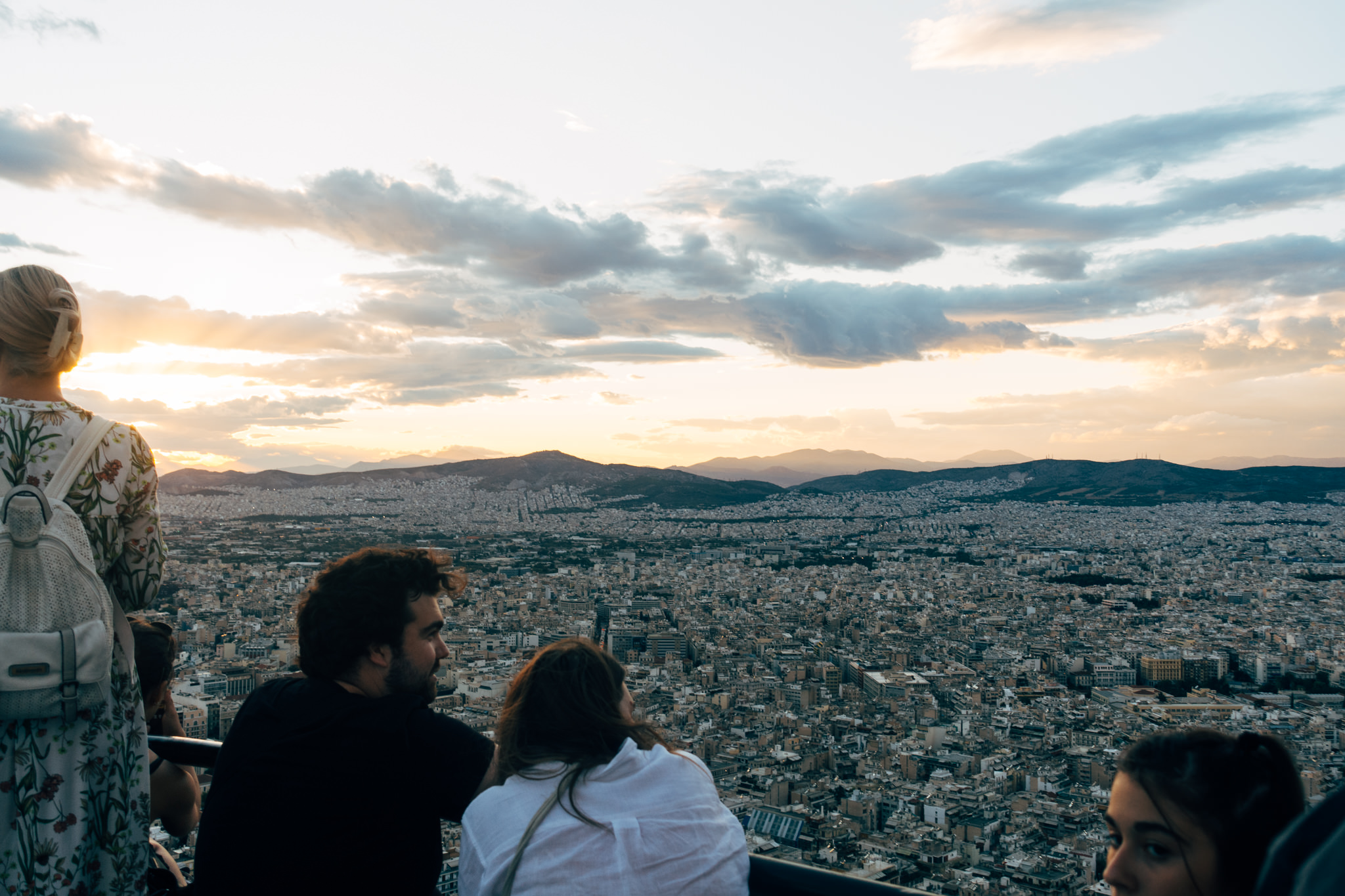 Tourists view sunset over Athens from Mount Lycabettus.