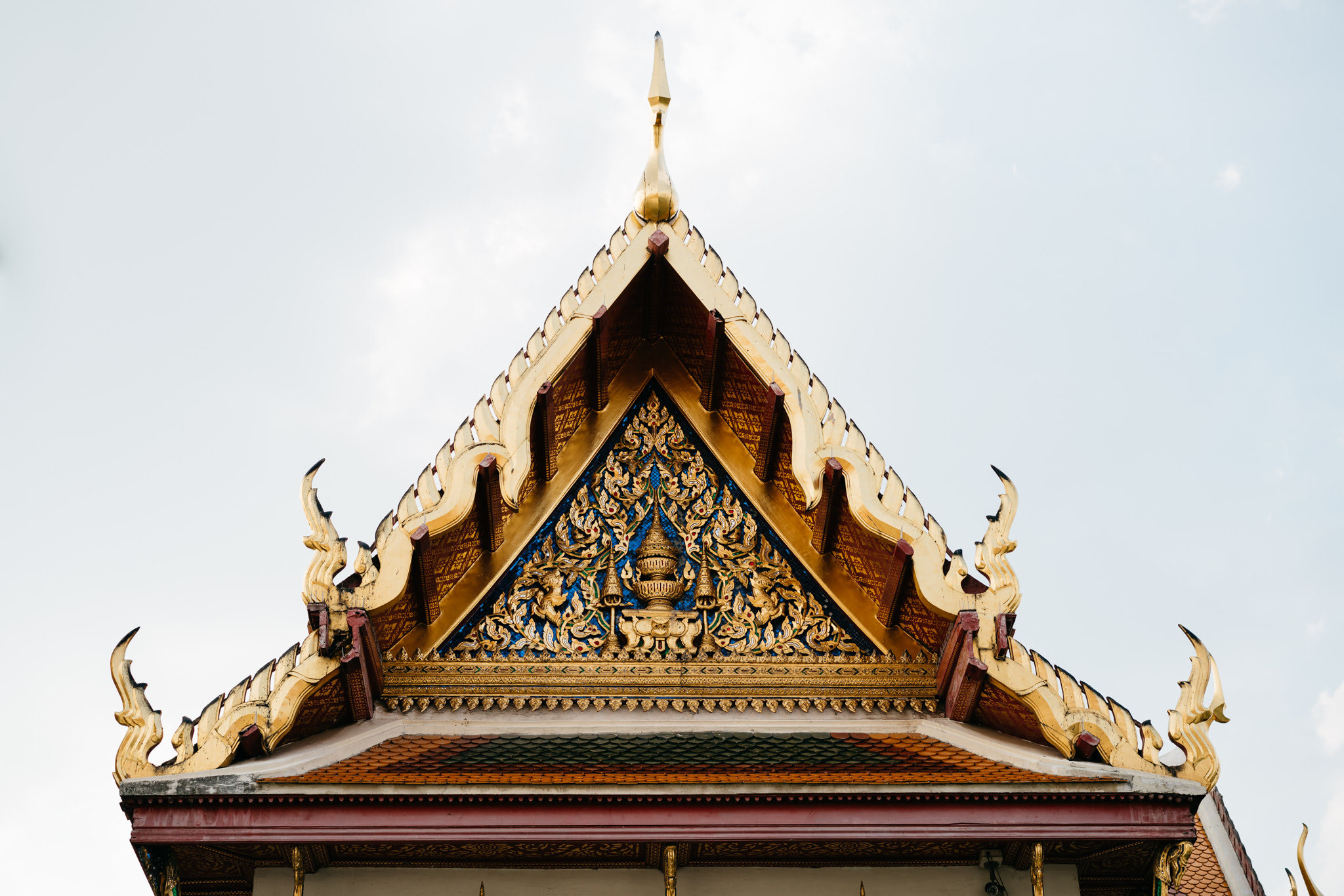 Ornate golden gable of Wat Benchamabophit temple in Bangkok.