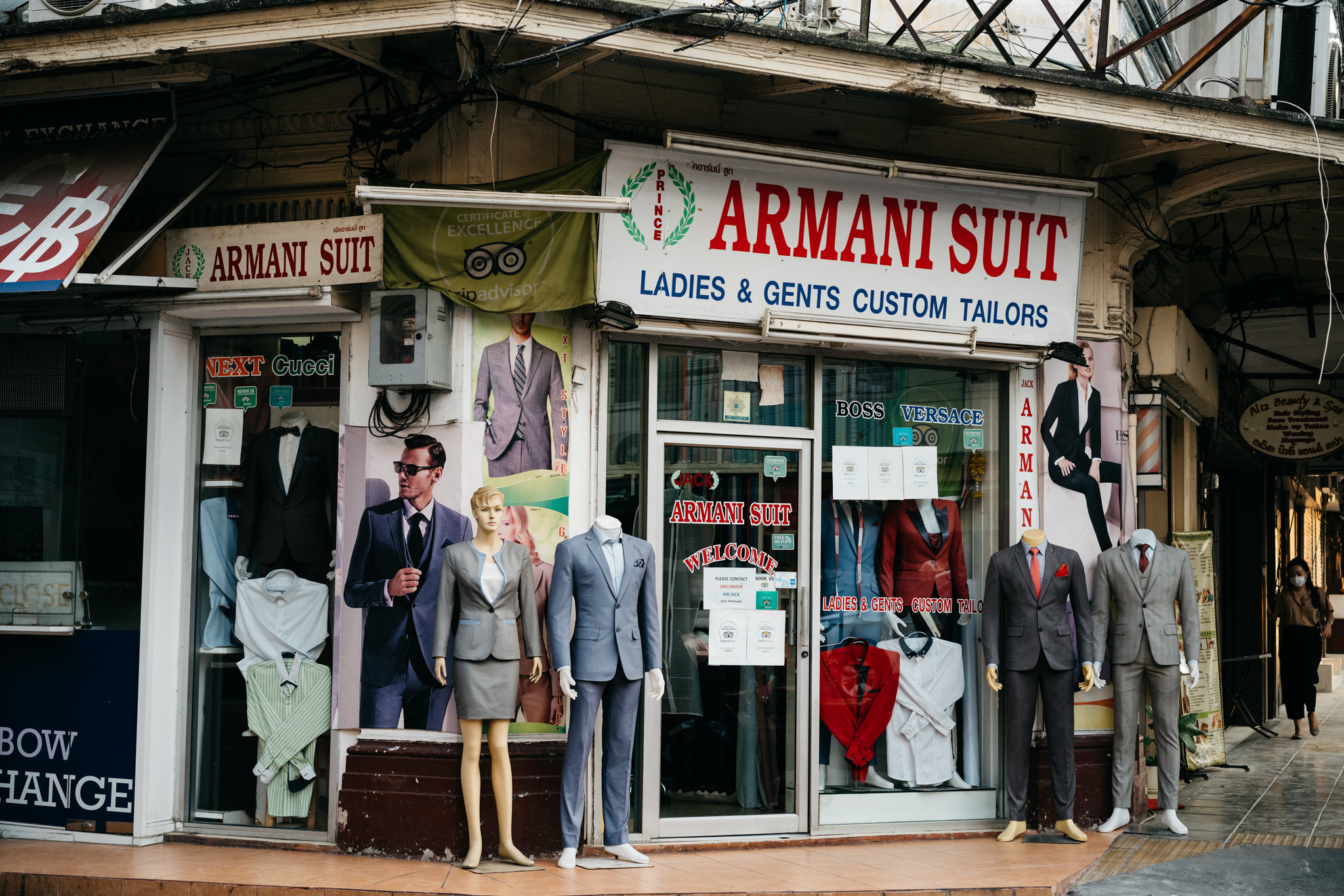 Armani Suit, Bangkok custom tailor shop storefront with mannequins displaying suits.