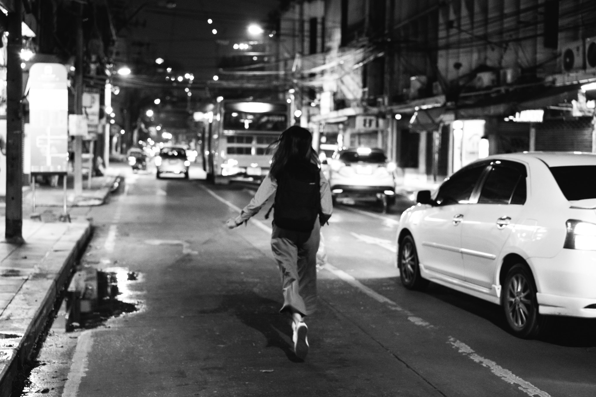 Woman running at night in Bangkok, Thailand.