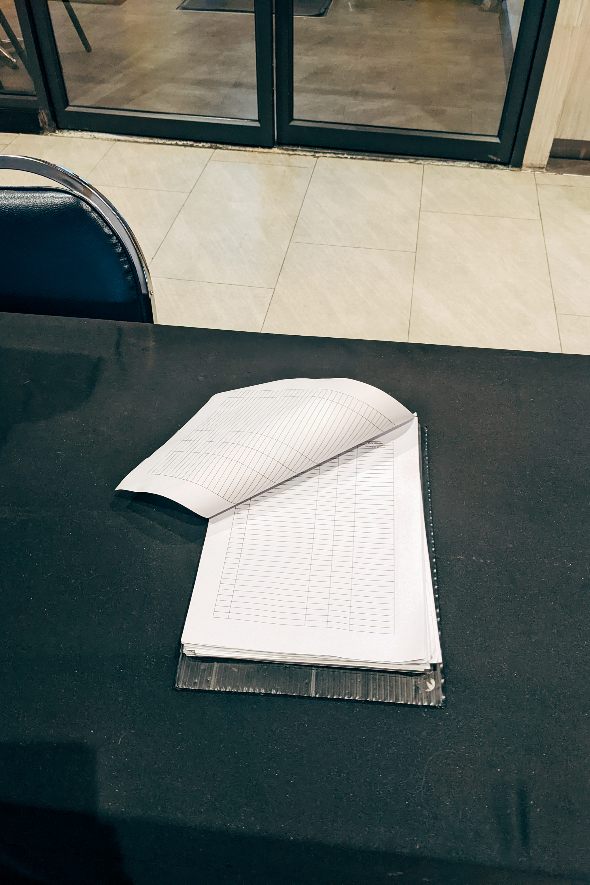 Open contact list on a black table.