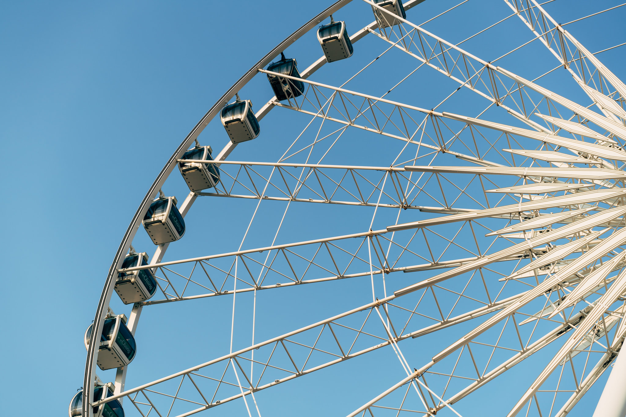 Bangkok Ferris wheel against a clear blue sky.
