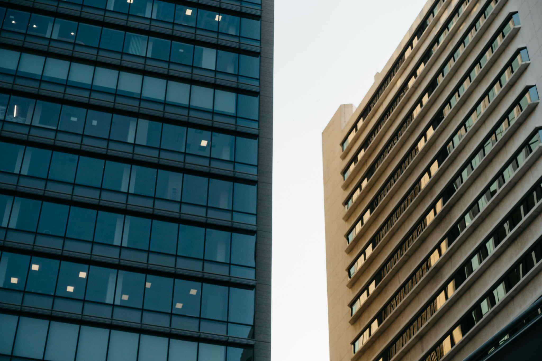Two modern Bangkok buildings side-by-side.