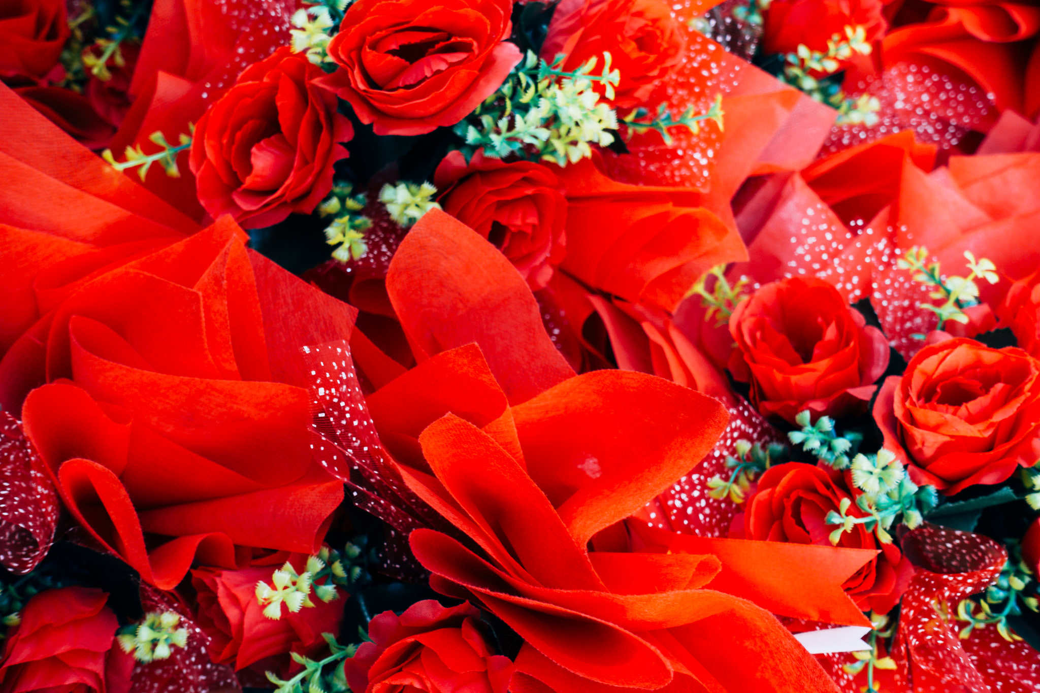 Close-up of a bouquet of artificial red roses.