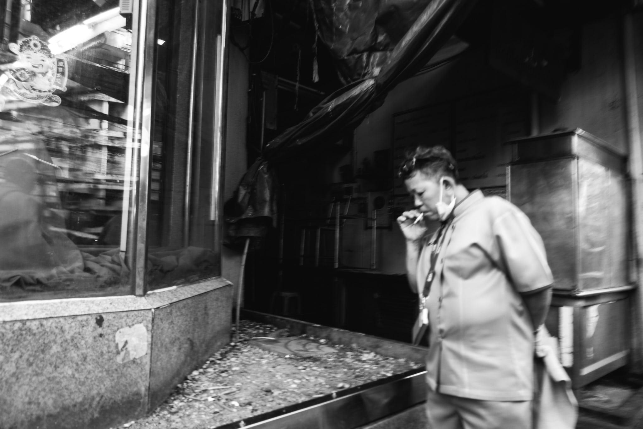 Black and white photo of a woman smoking in Bangkok, Thailand.