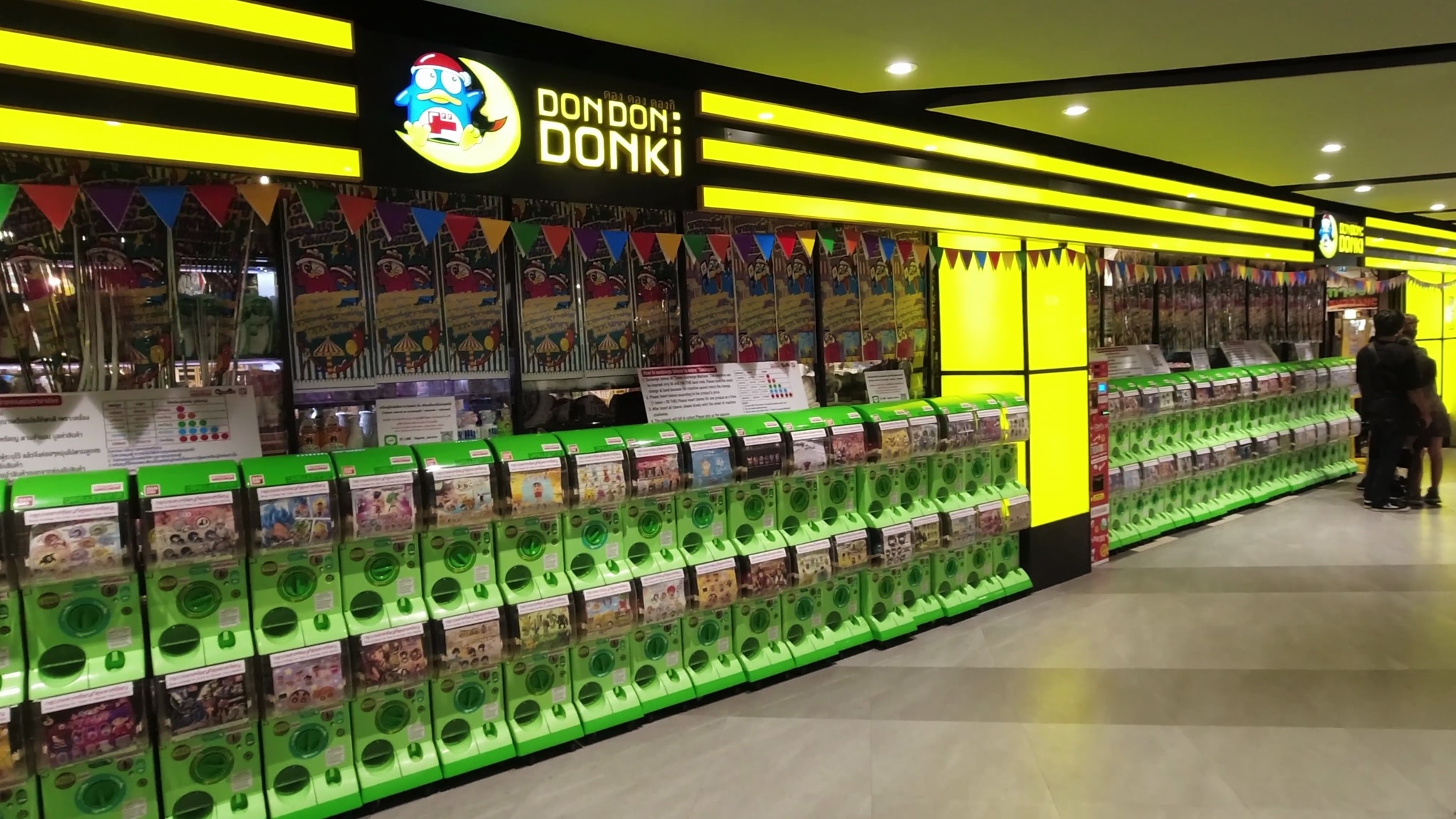 Don Don Donki Bangkok Japanese supermarket with numerous green gachapon machines.