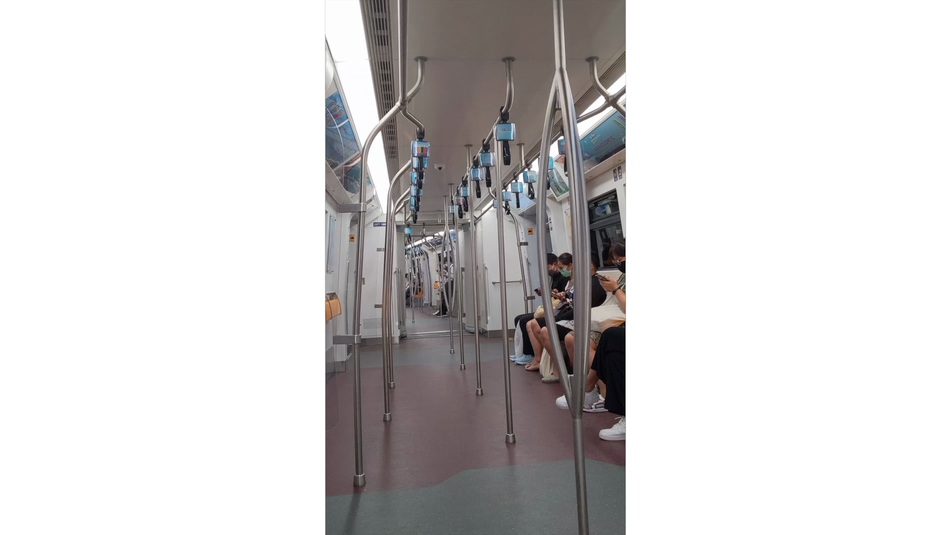 Passengers seated on a Bangkok train.