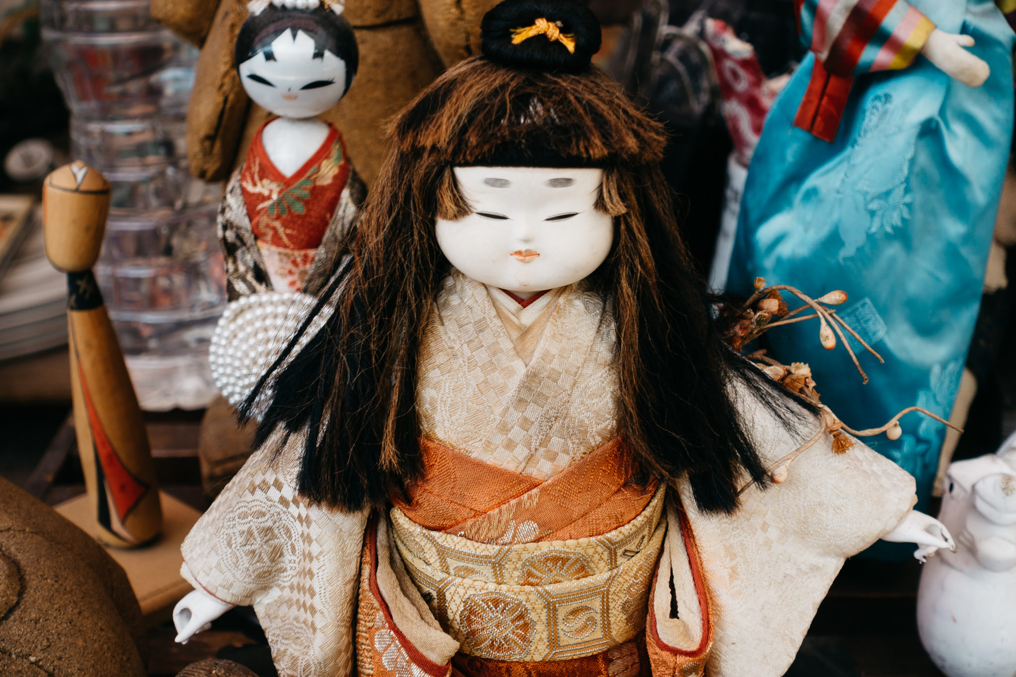 Close-up of a small Asian doll in traditional clothing.