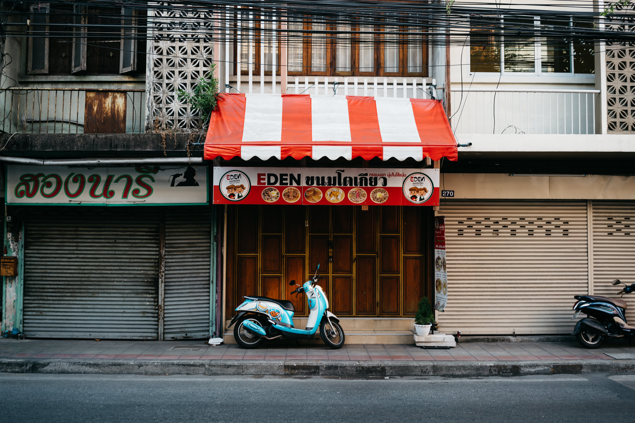 Scooter parked outside an Eden restaurant in Thailand.