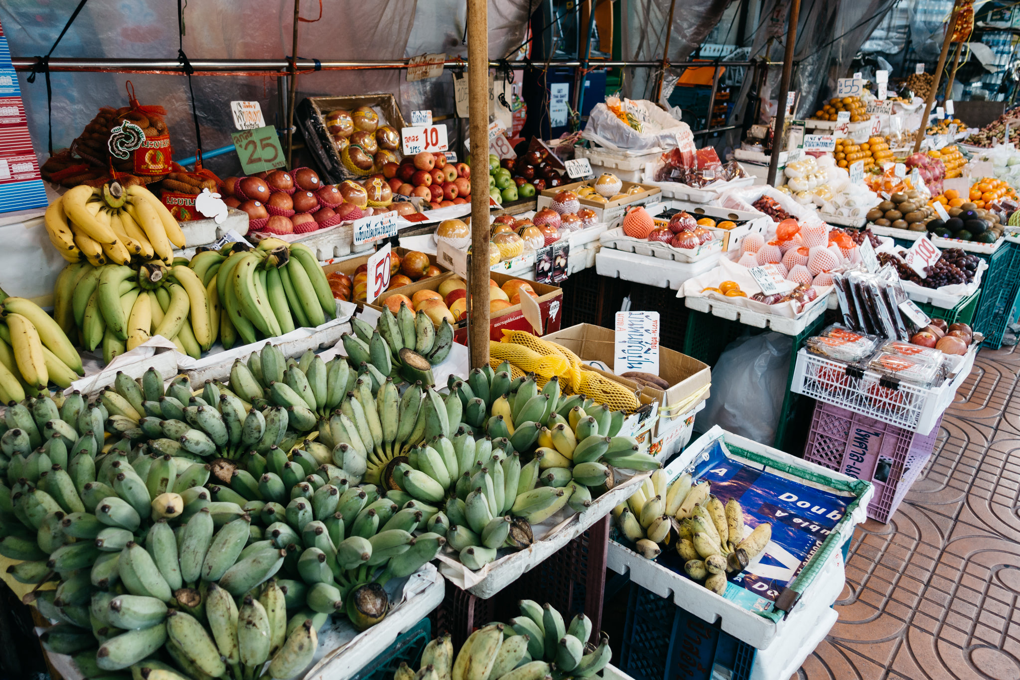 A variety of fruits for sale at a Thai market.