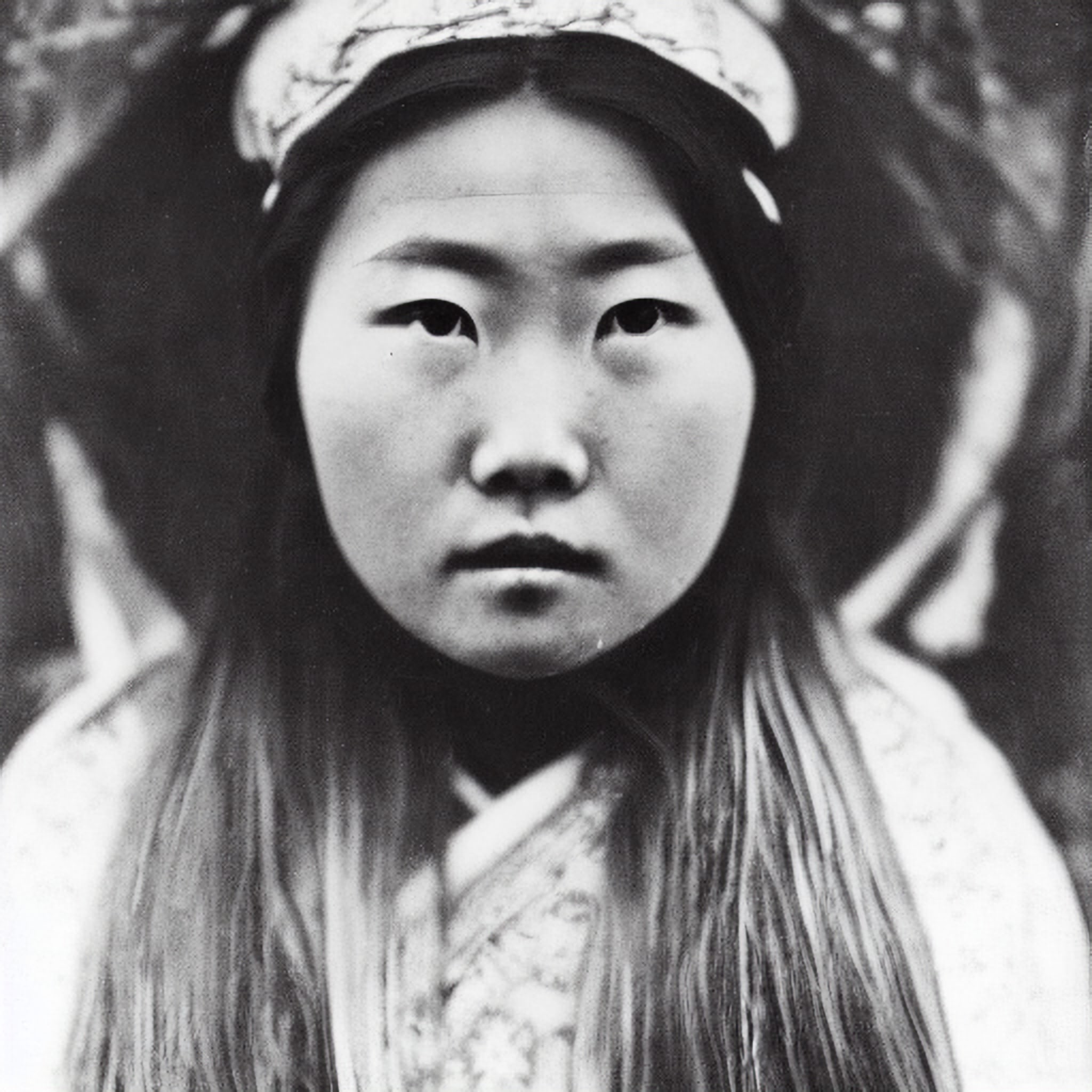 Black and white portrait of a young Chinese woman wearing a headpiece.
