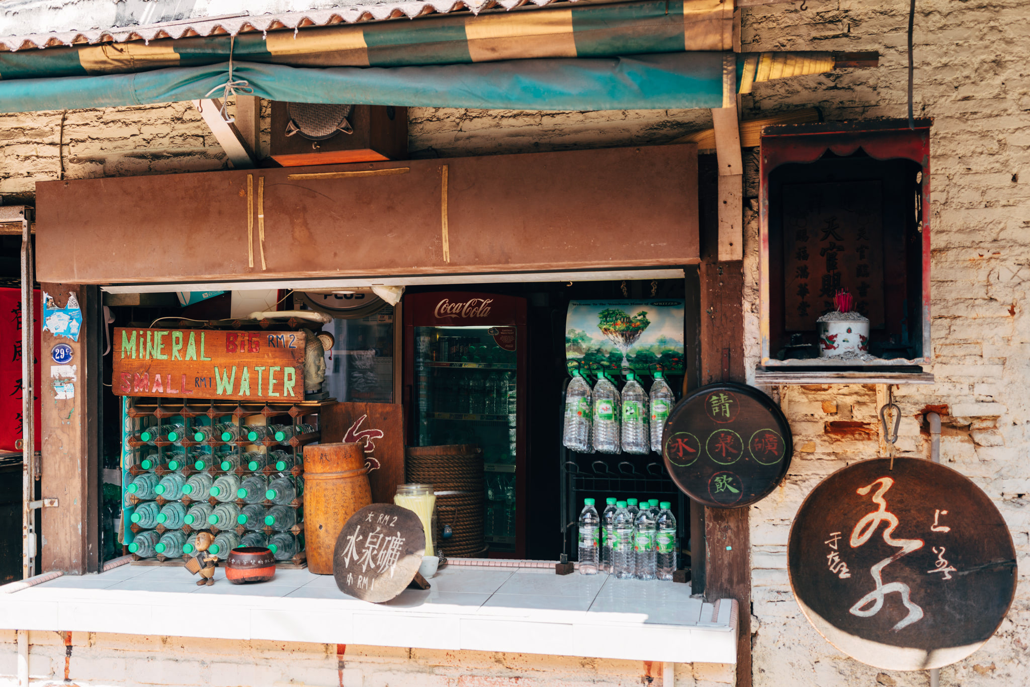 A rustic shop in Malacca, Malaysia, selling mineral water and Coca-Cola.