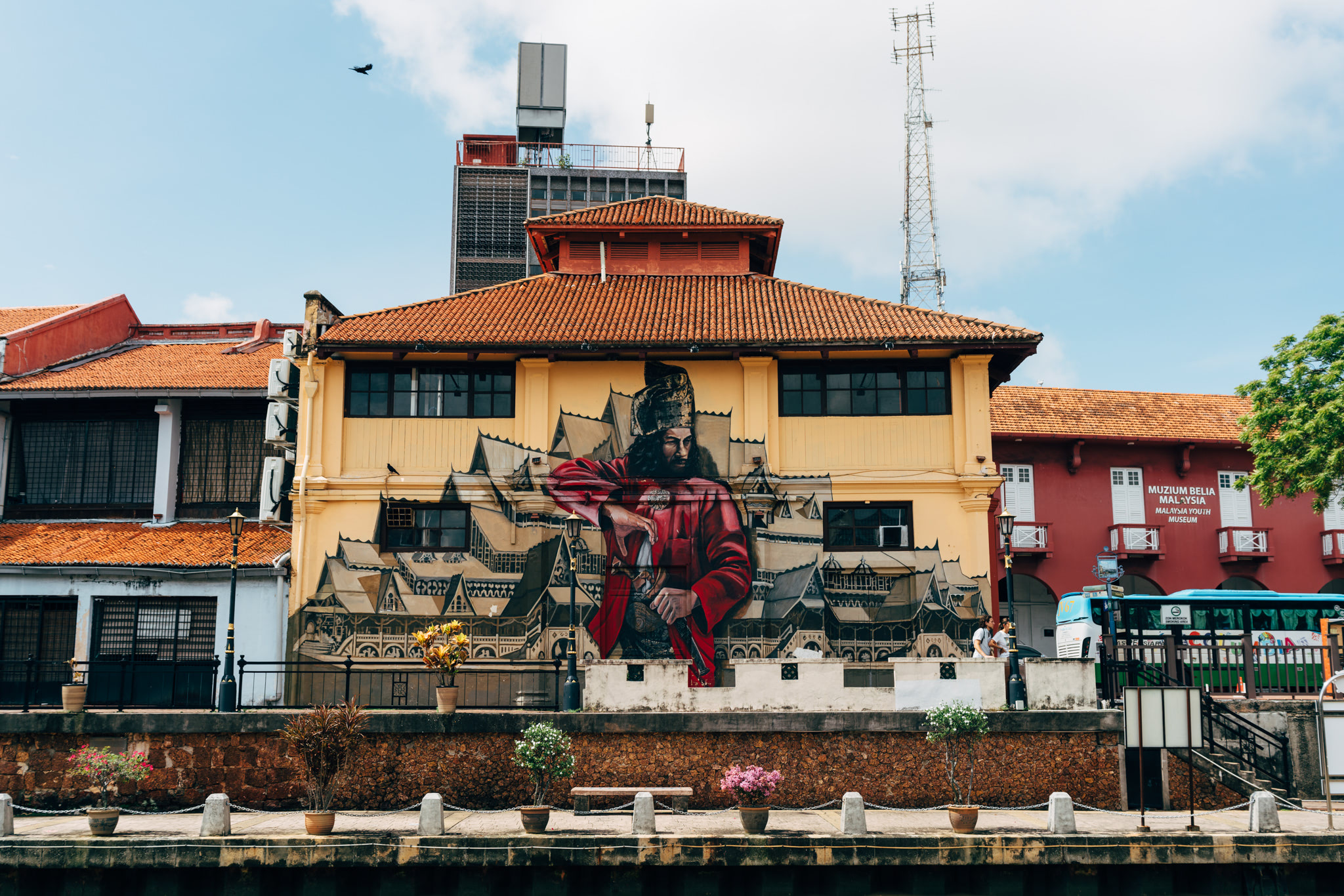 Large mural of a historical figure on a building in Malacca, Malaysia.