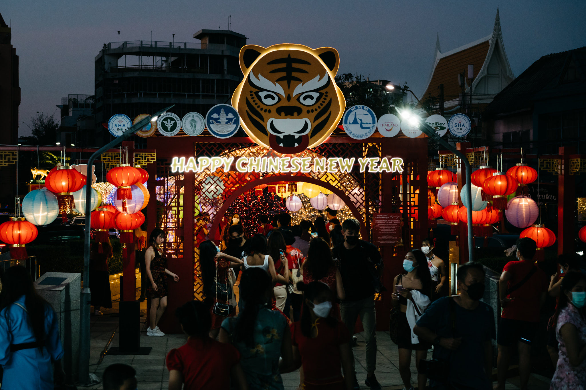Happy Chinese New Year celebration in Bangkok with a tiger head decoration and red lanterns.