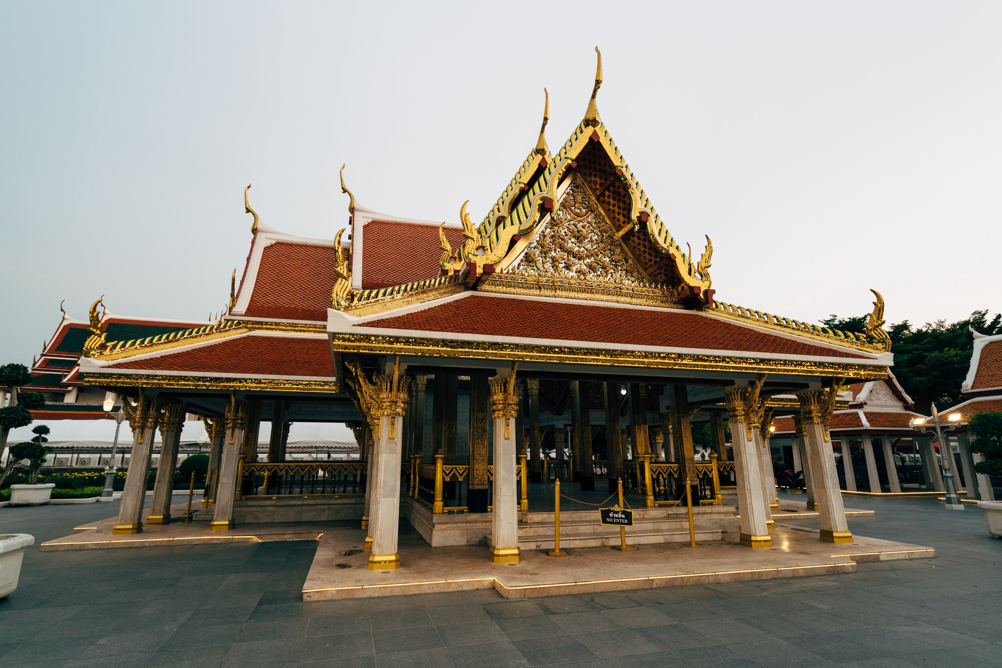 Ornate Thai pavilion with red roof and gold detailing.