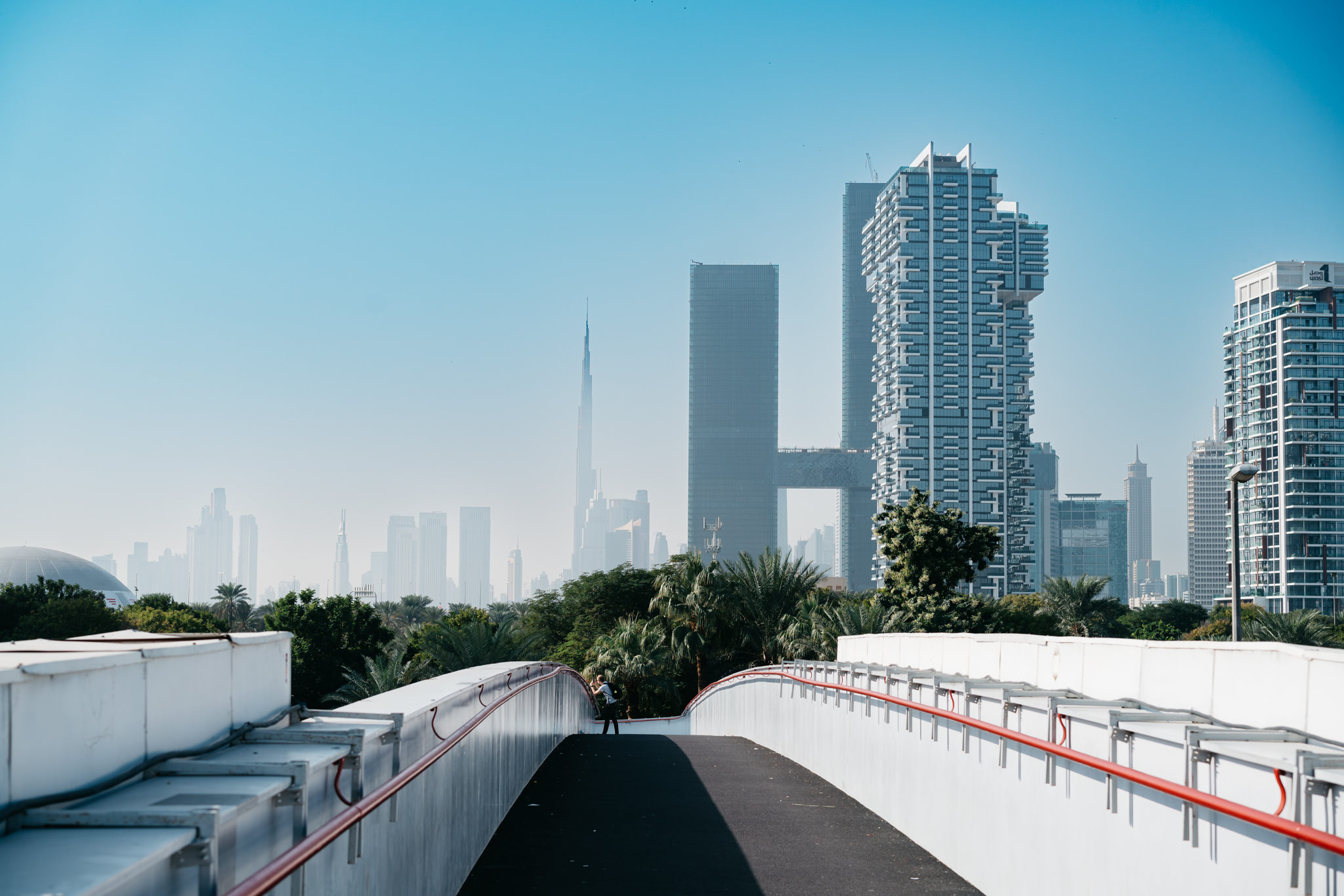 Dubai cityscape viewed from a pedestrian bridge.