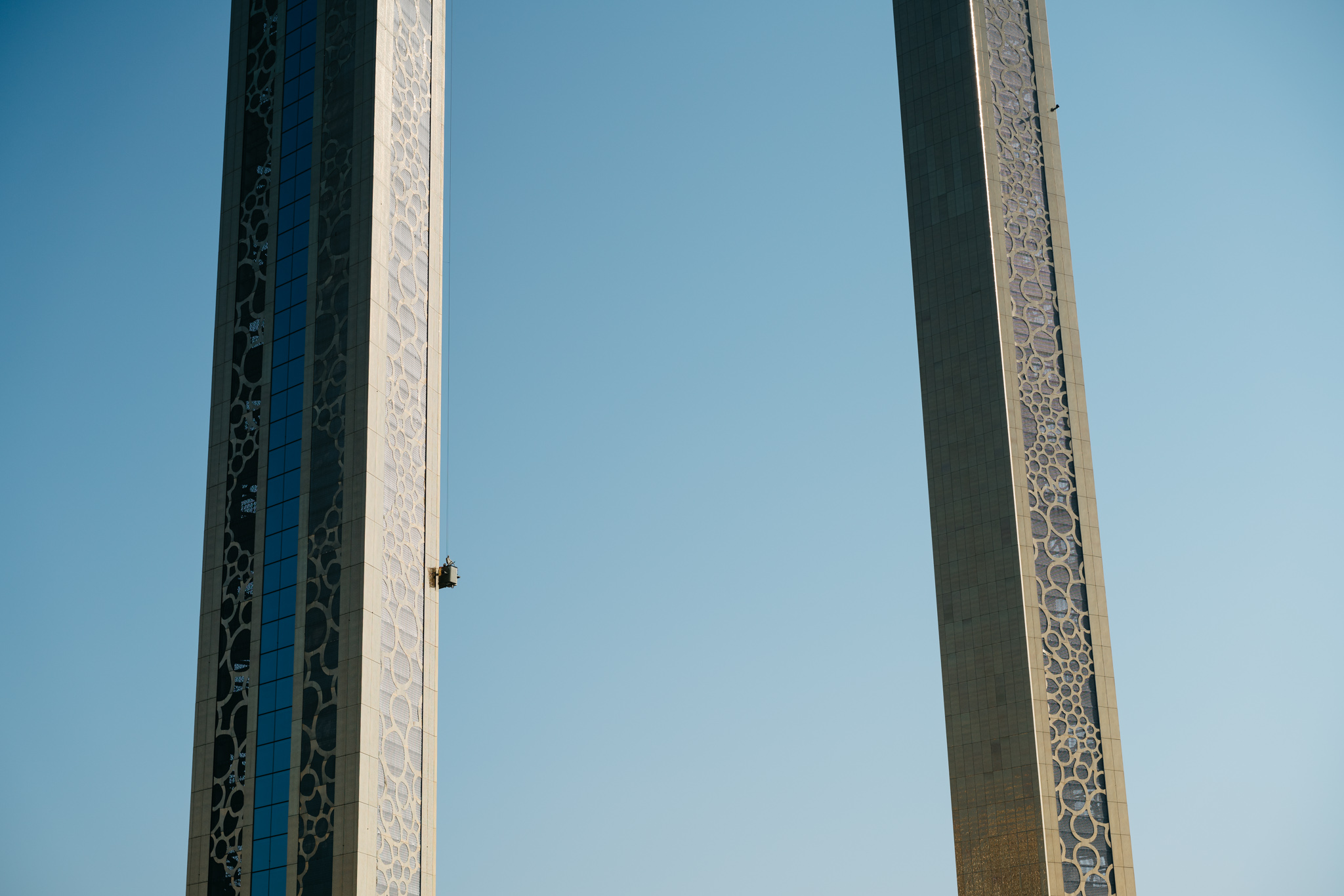 The Frame Dubai monument with a worker in a lift.