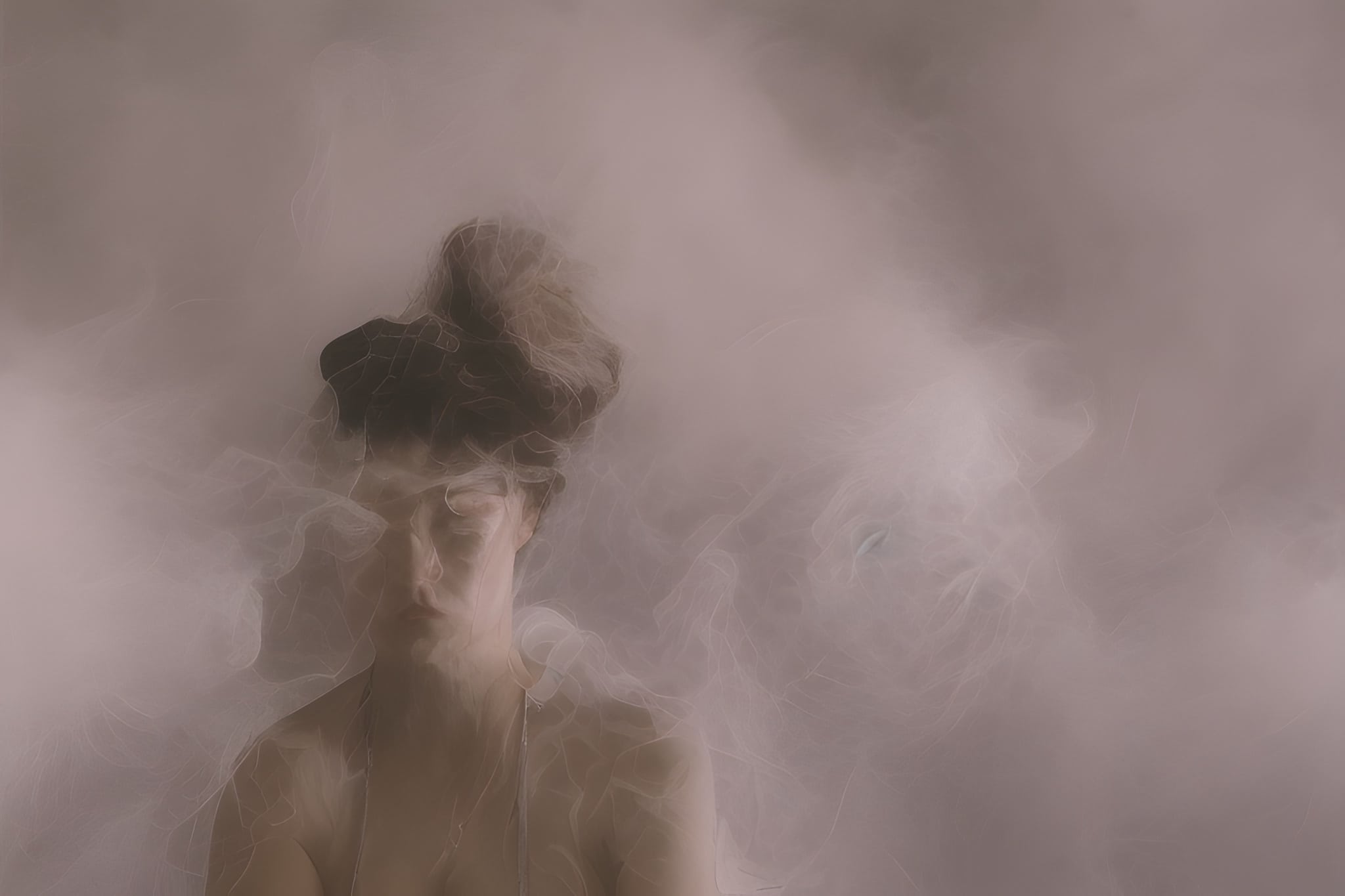 Portrait of a woman partially obscured by smoke or mist.