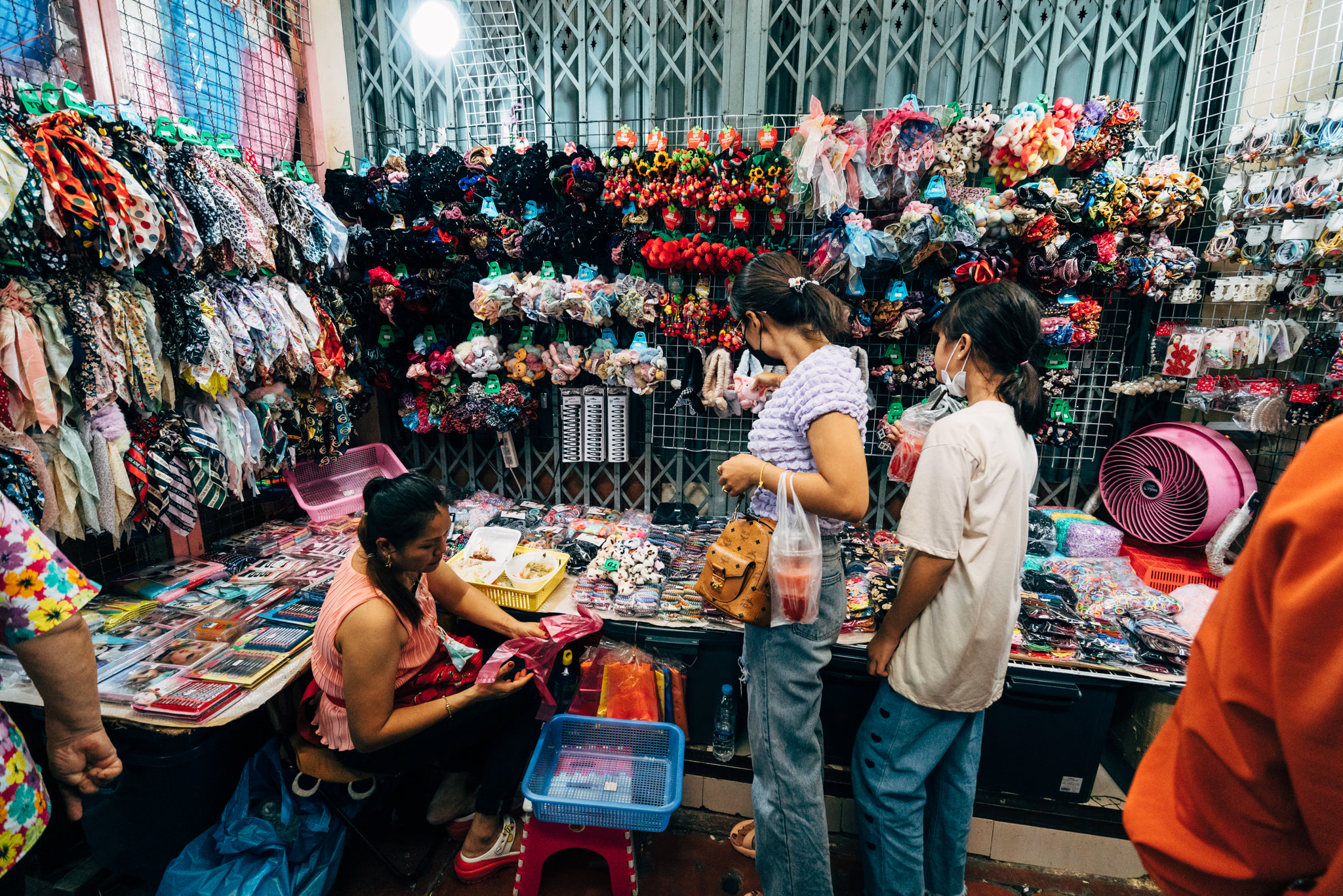 Thai shopping district stall selling hair accessories and scarves.