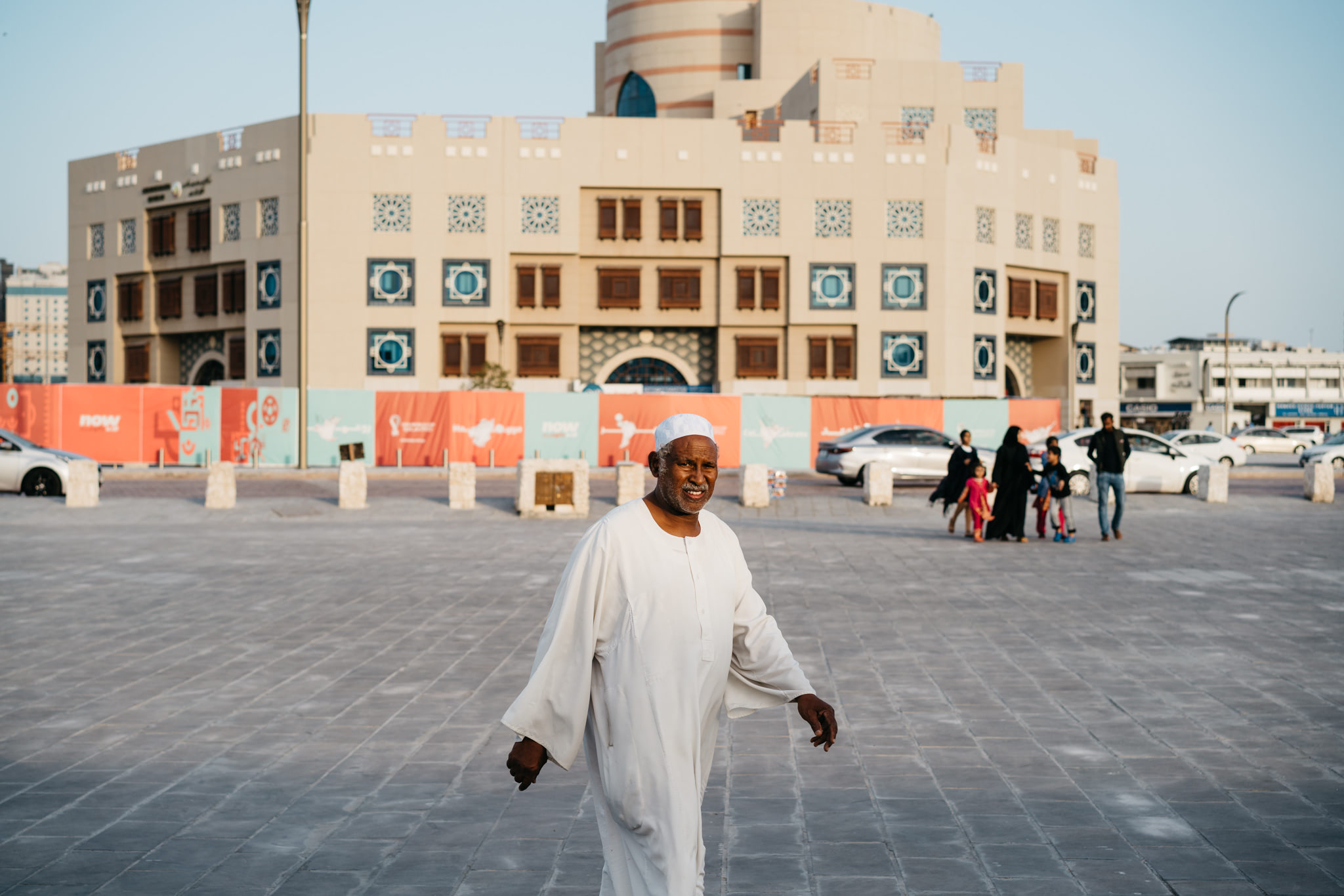 Man in white thobe walking in Doha, Qatar.