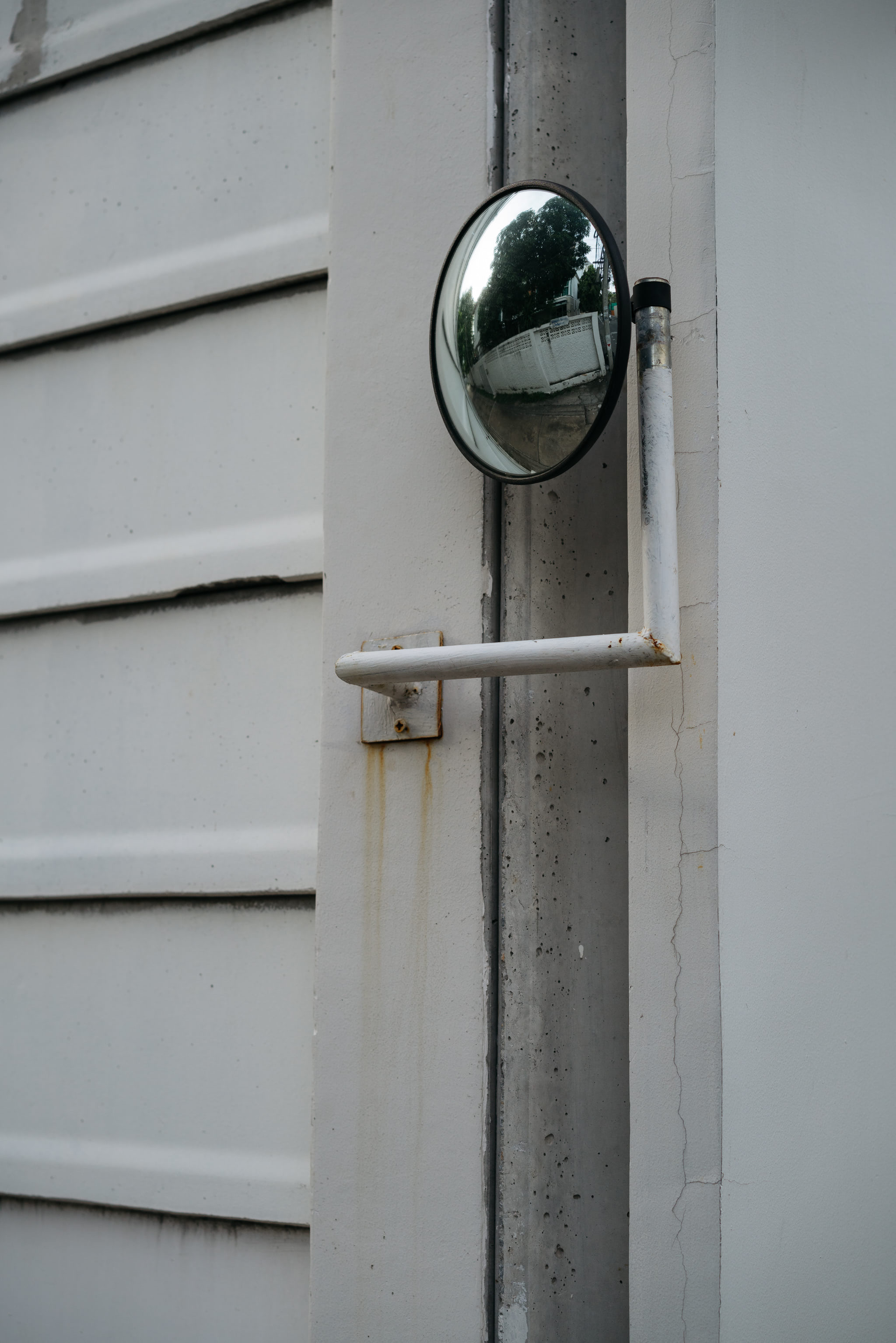 Convex security mirror mounted on a white wall.