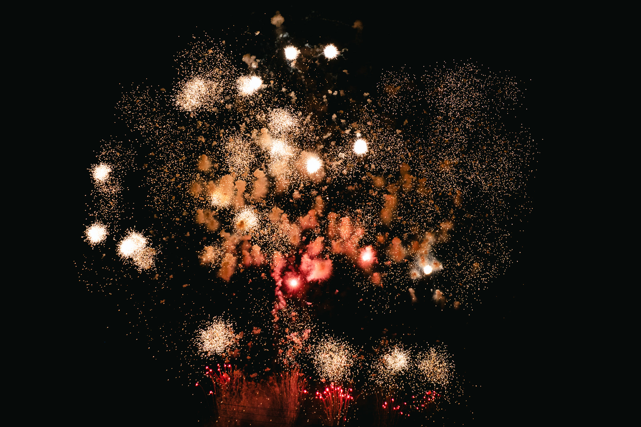 Fireworks exploding in the night sky.