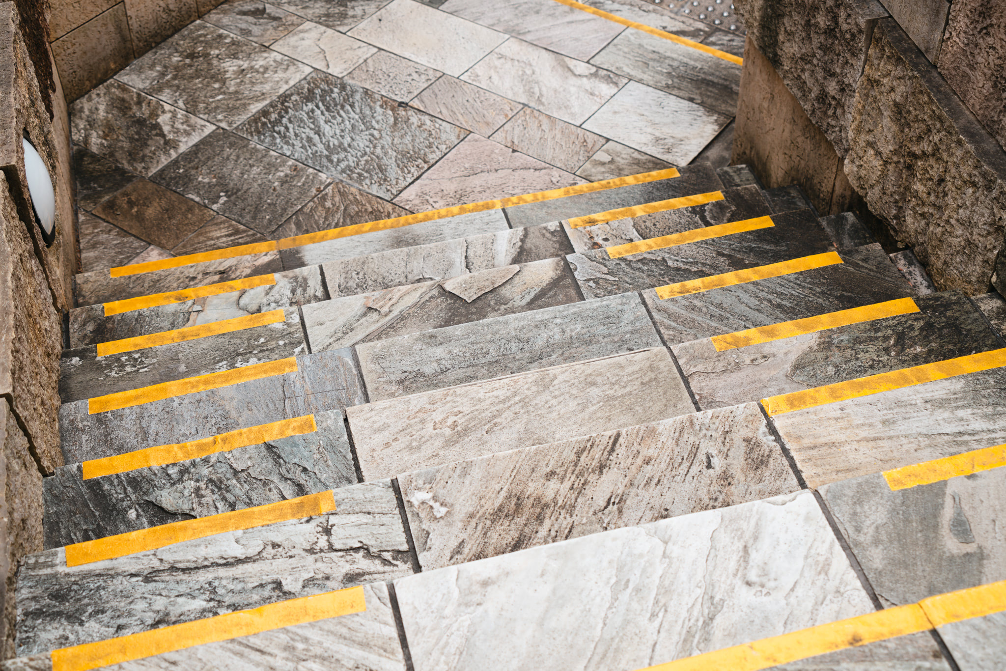 Stone steps with yellow warning stripes.