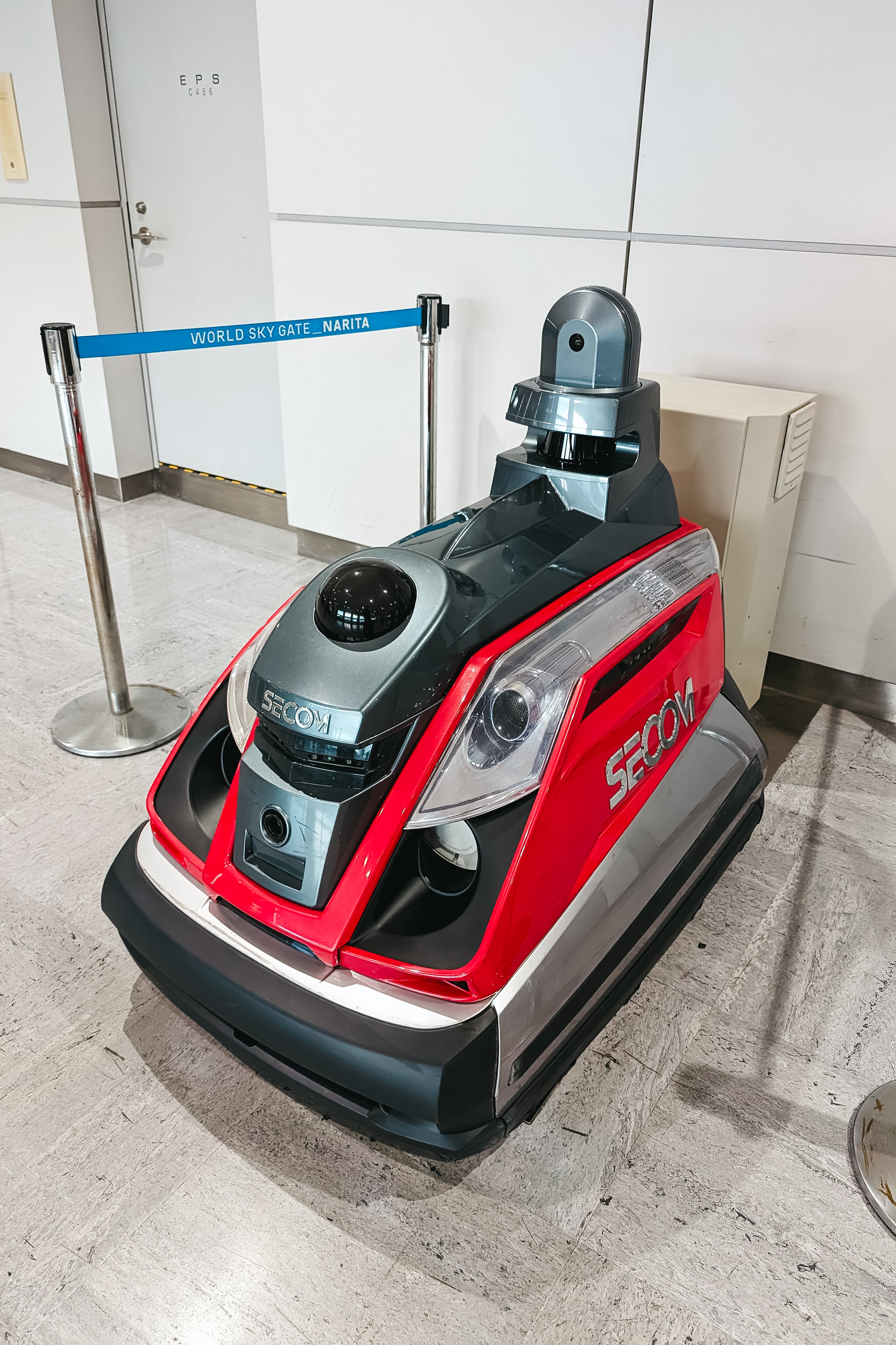 Red and gray SECOM security robot at Narita airport.
