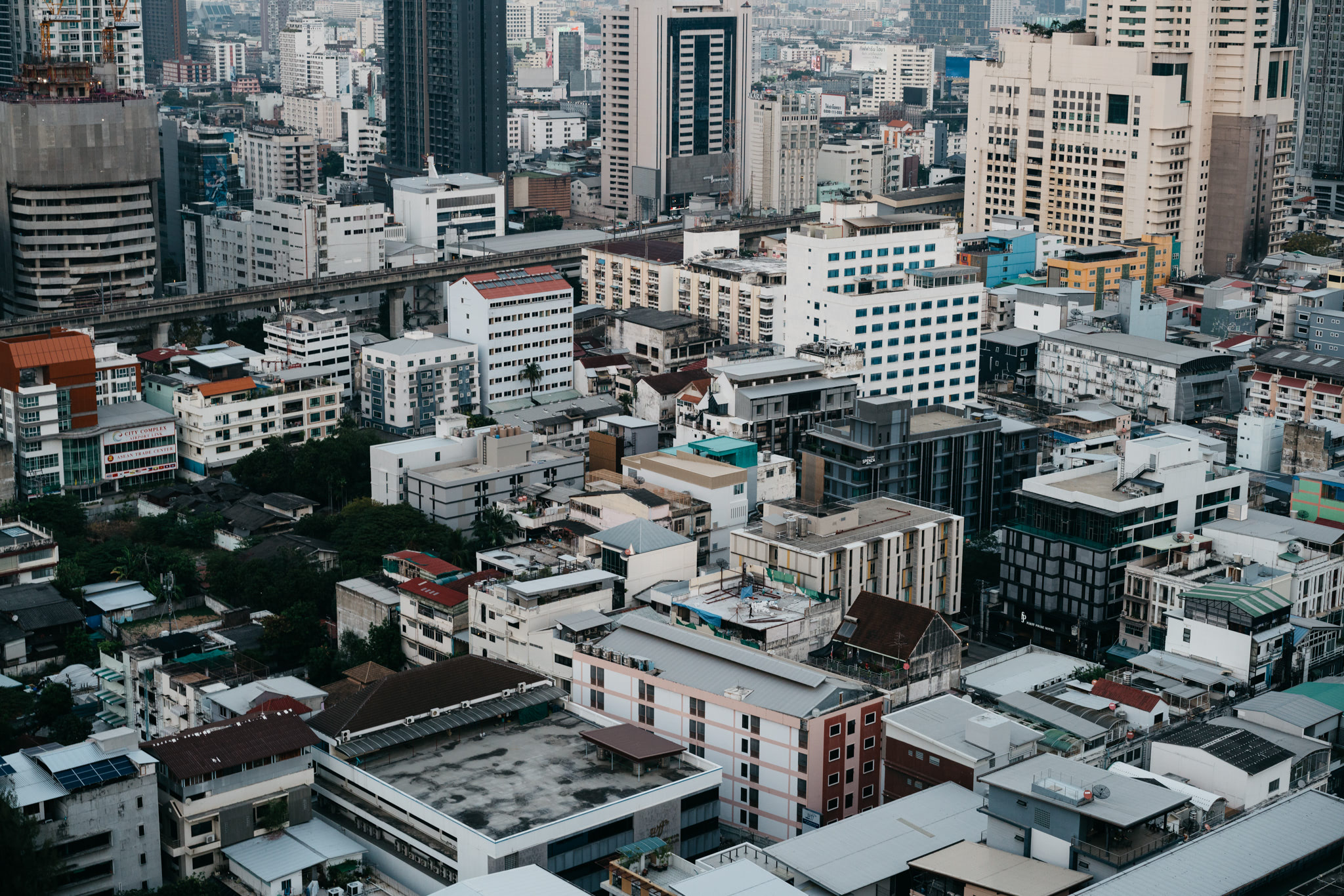 Aerial view of dense Bangkok cityscape with numerous buildings.