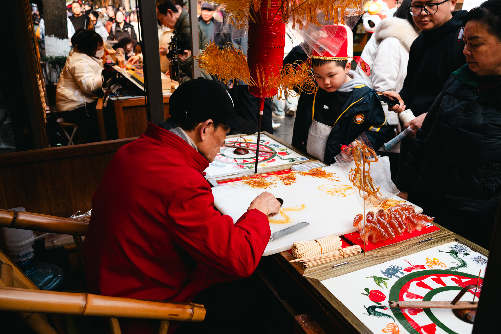 A vendor in Chengdu, China makes sugar candy.