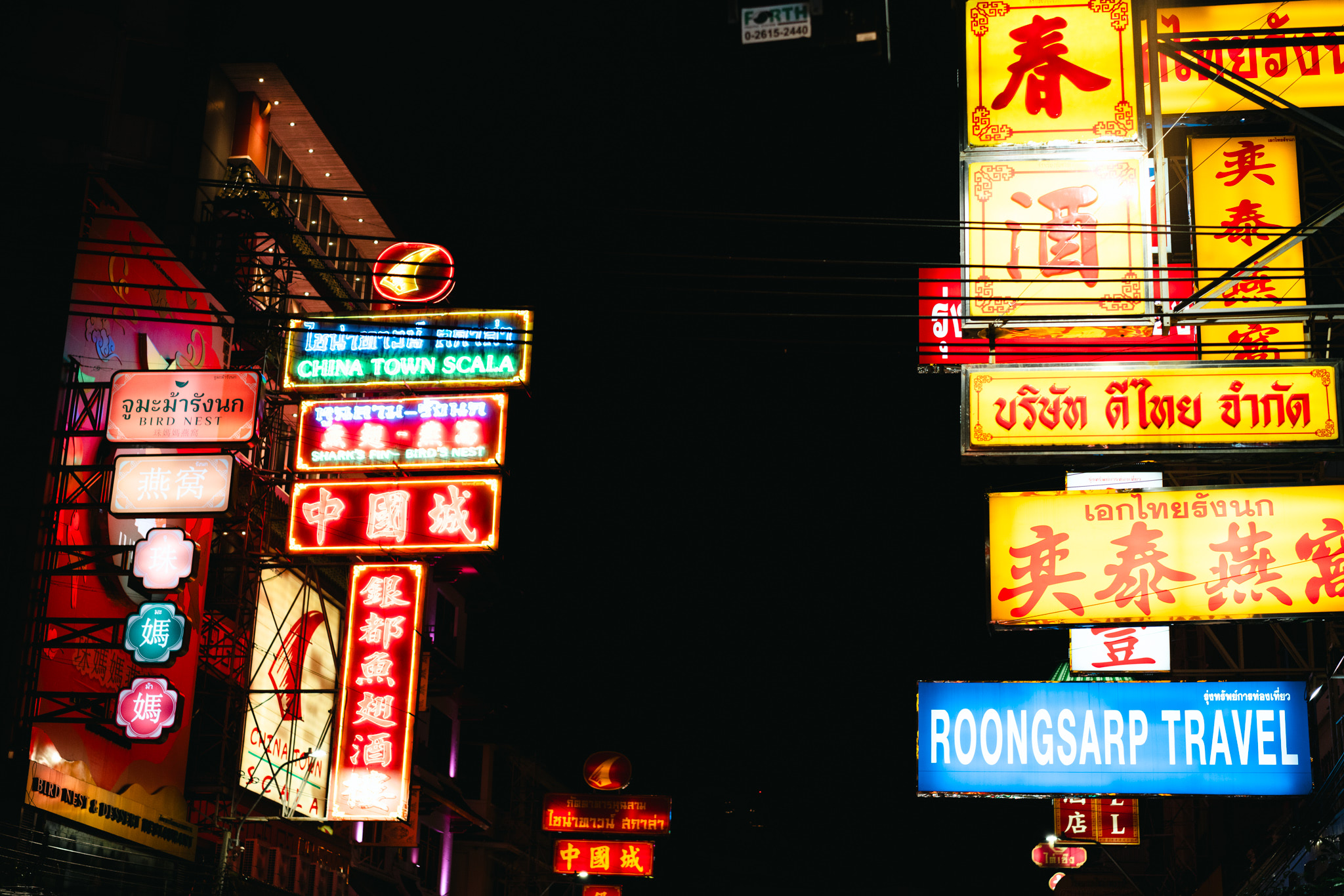 Brightly lit neon signs in Yaowarat, Bangkok's Chinatown.