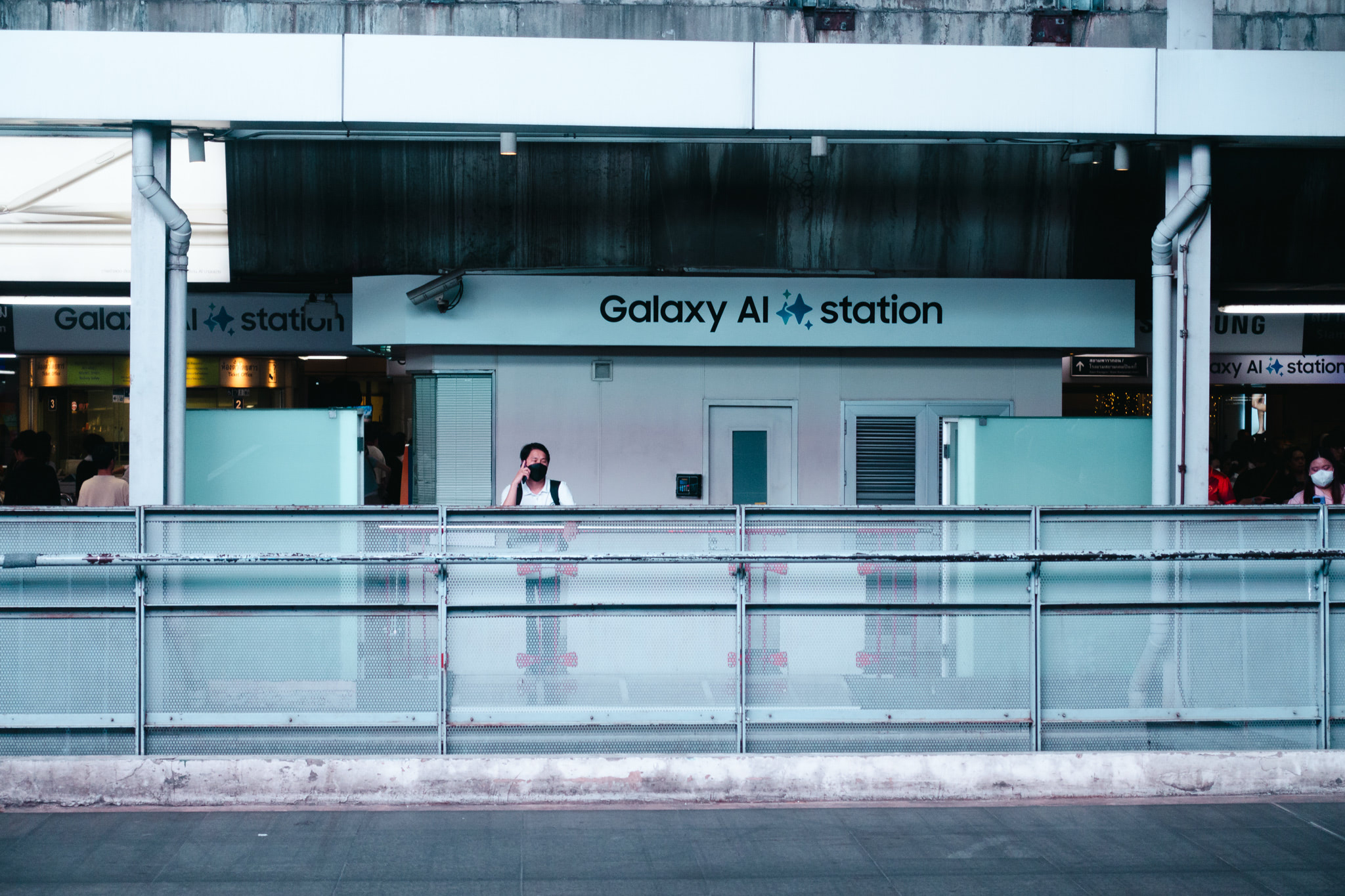 Person wearing a mask at a Galaxy AI station.