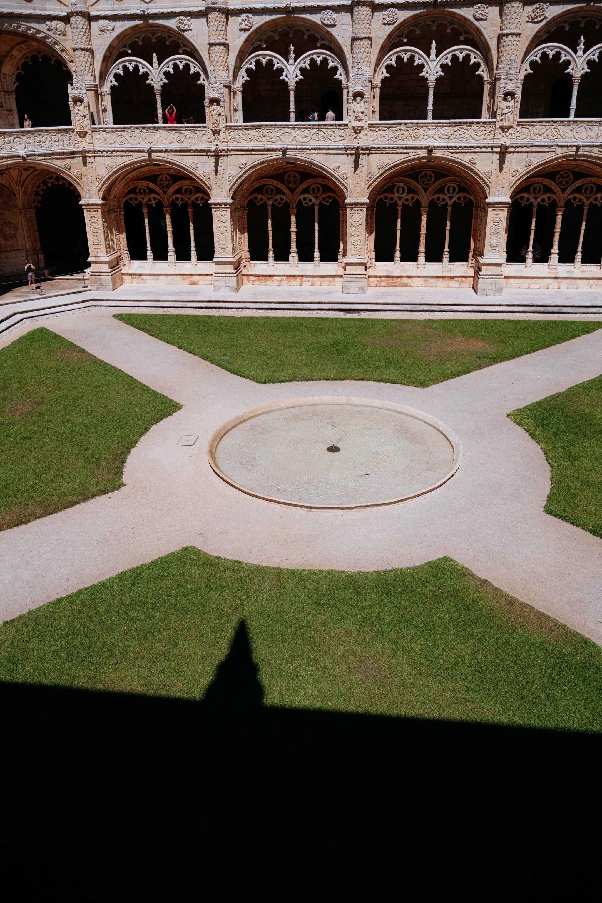 Aerial view of Jerónimos Monastery cloister with central fountain.