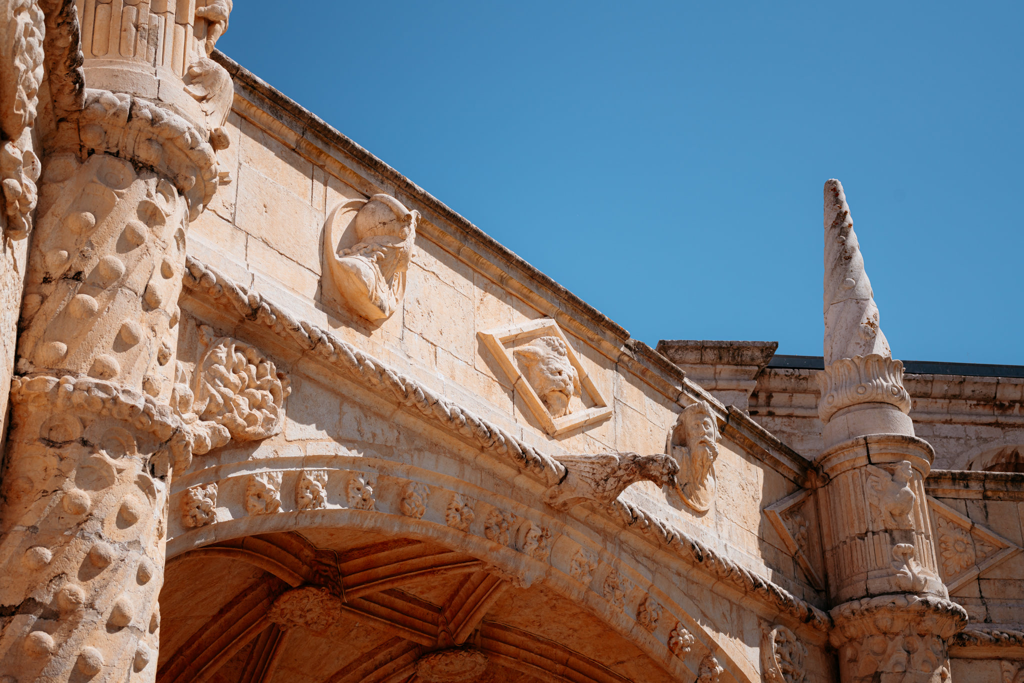 Intricate stone carvings on Jerónimos Monastery archway.