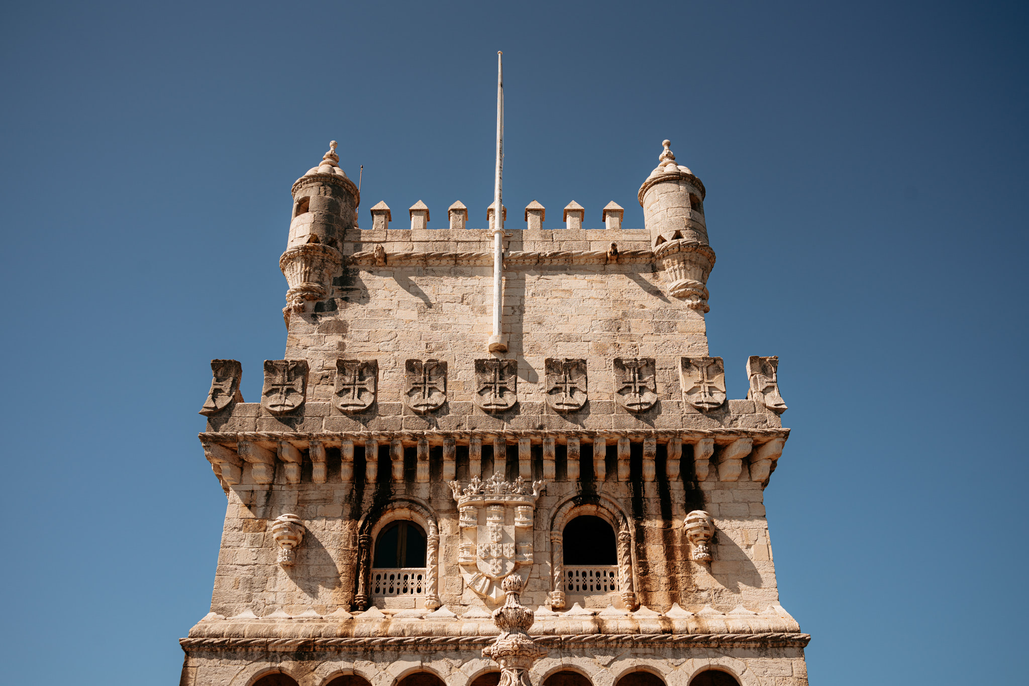 Belém Tower, Lisbon, upper section against a clear blue sky.