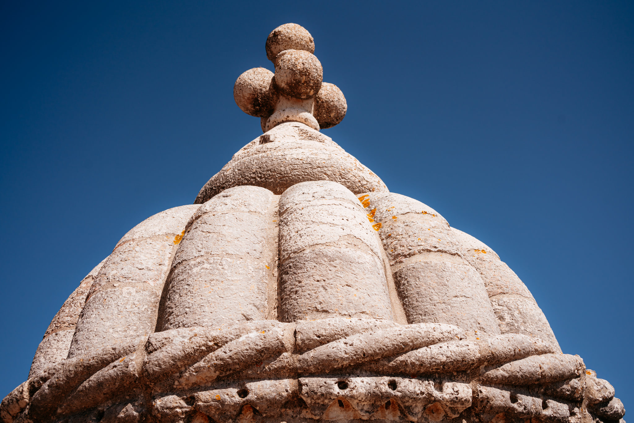 Close-up of the stone dome and finial atop the Belém Tower in Lisbon, Portugal.
